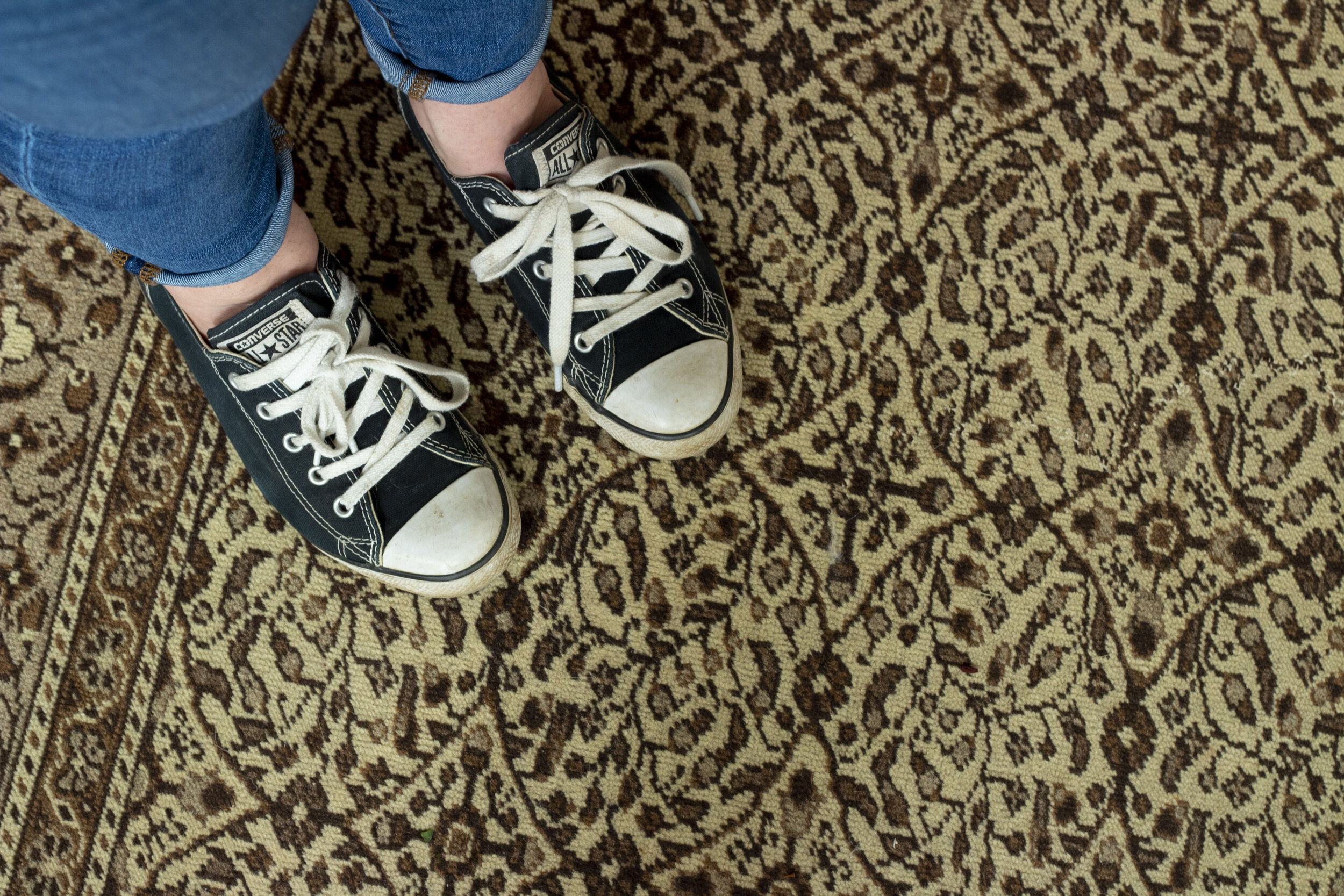 standing on brown vintage rug, shoe shot