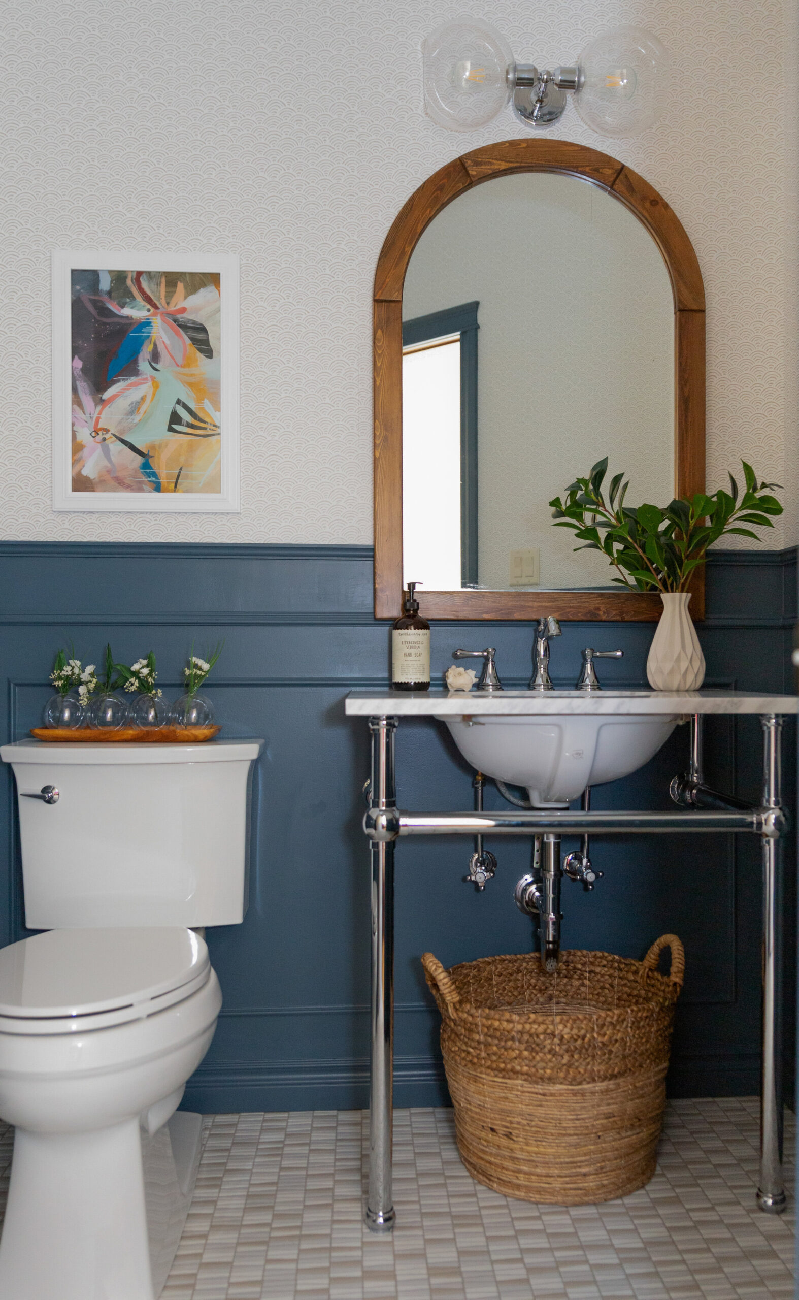 A wheelchair frendly tradtiional bathroom with paneling, wallpaper and a console sink