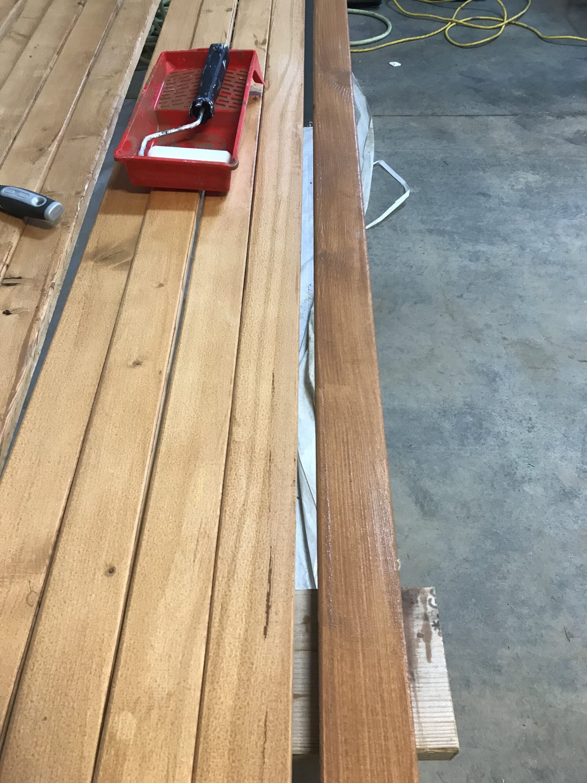 restaining one board darker showing other boards stacked next to them in lighter stain