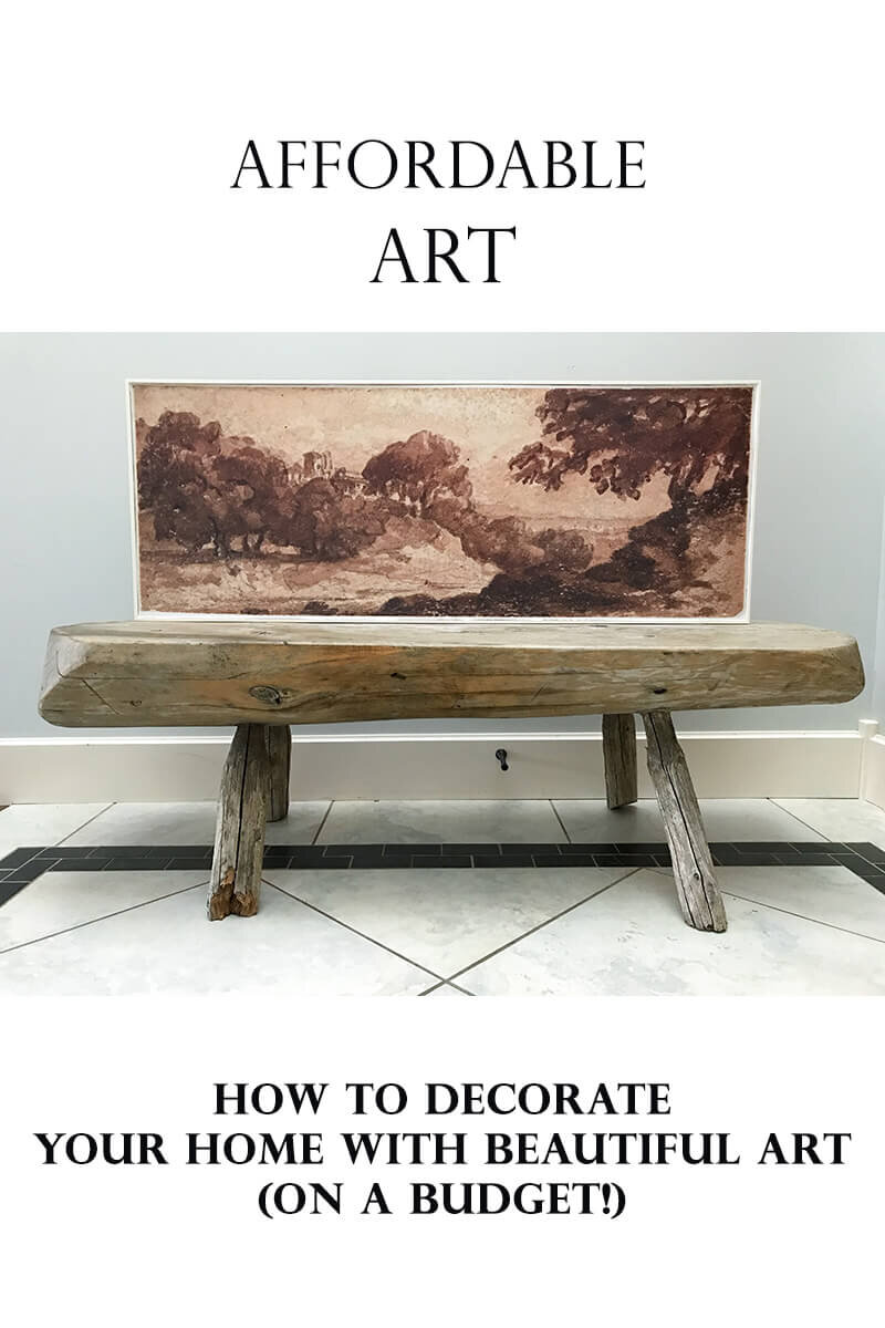 long horizontal vintage art sitting on a vintage bench with title" how to decorate your home with beautiful art on a budget"
