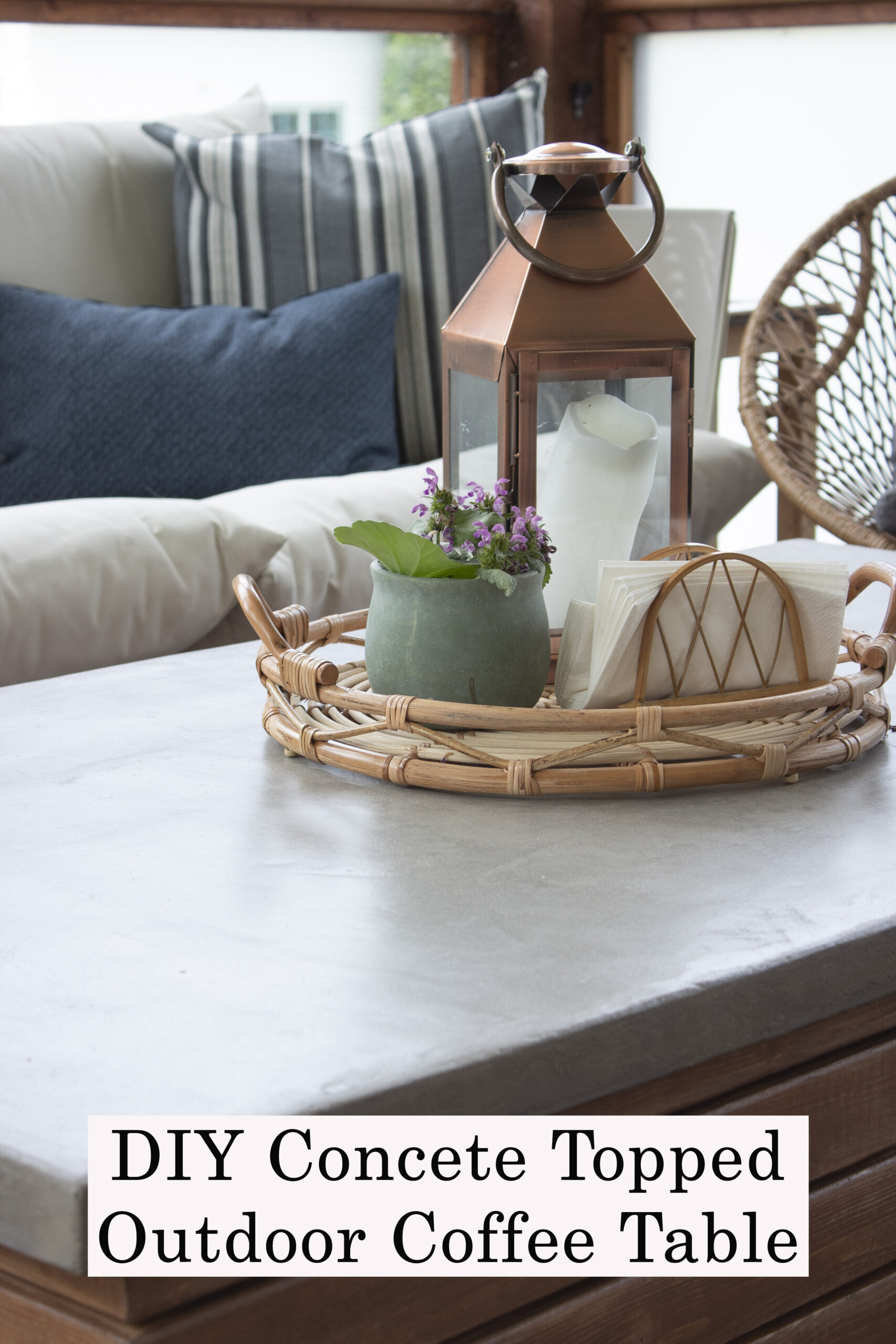 DIY concrete topped outdoor coffee table with tray on top and plant