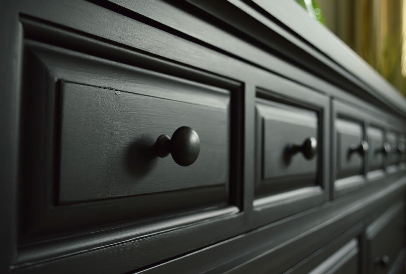 Close up of painted black finish on a dresser