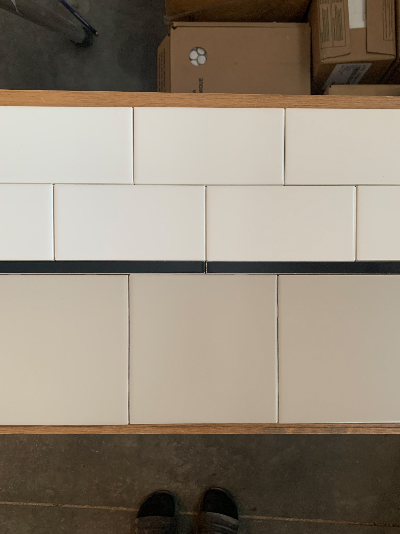 Subway tile in three different sizes and three differnt colours make up an interesting tile pattern.