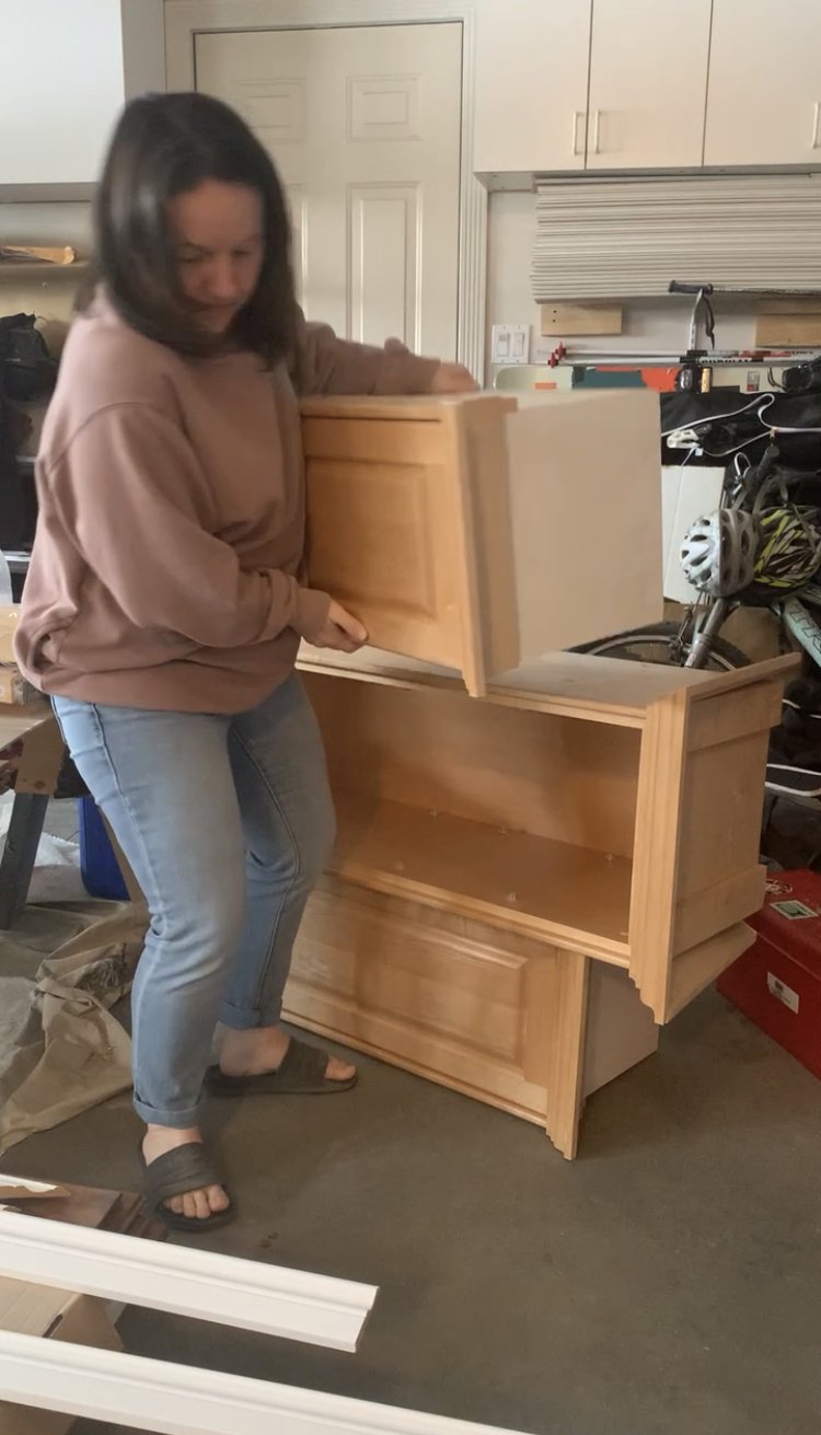 woman taking cabinets apart