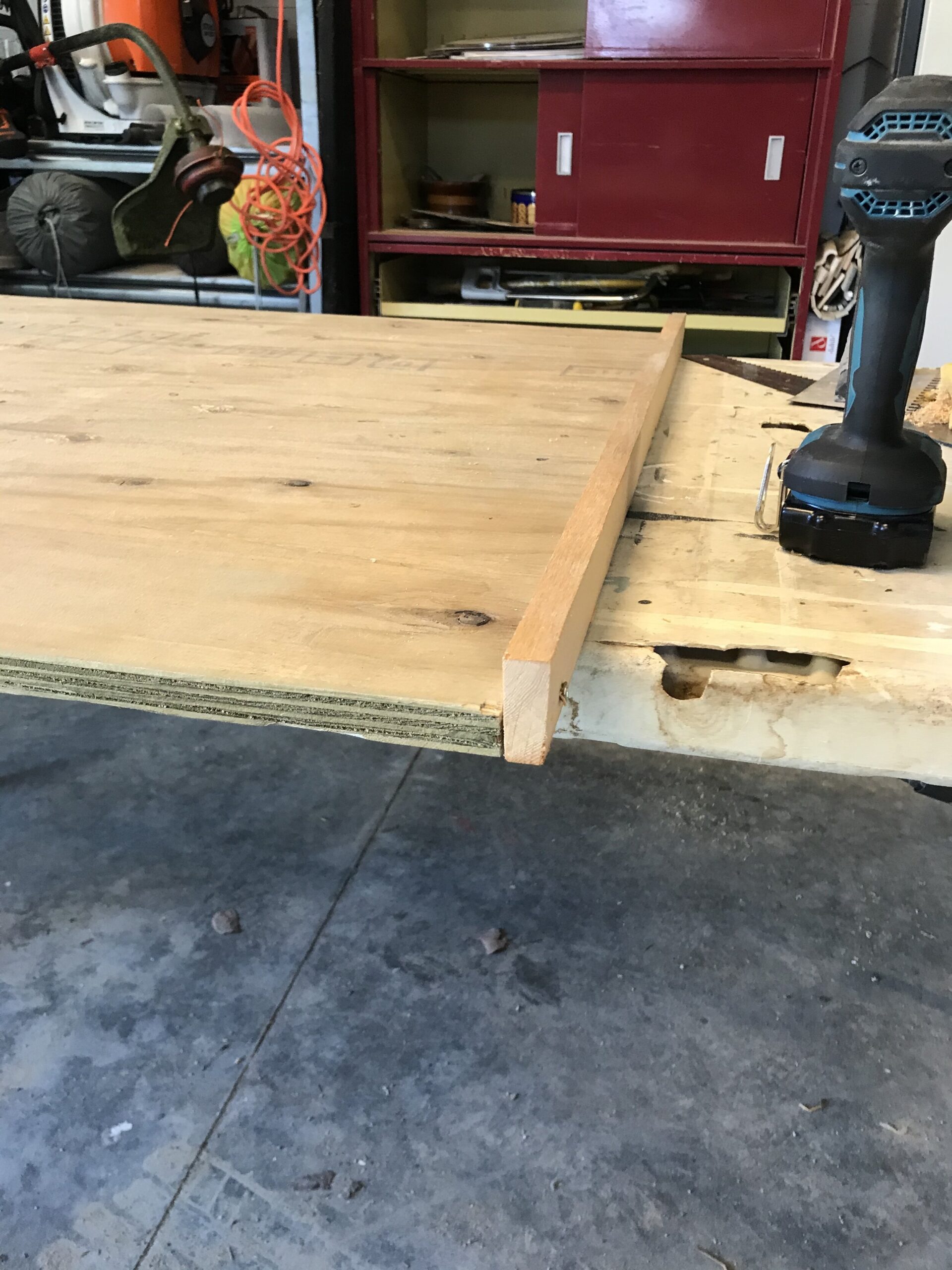 plywood with a 1x2' board screwed to its edge