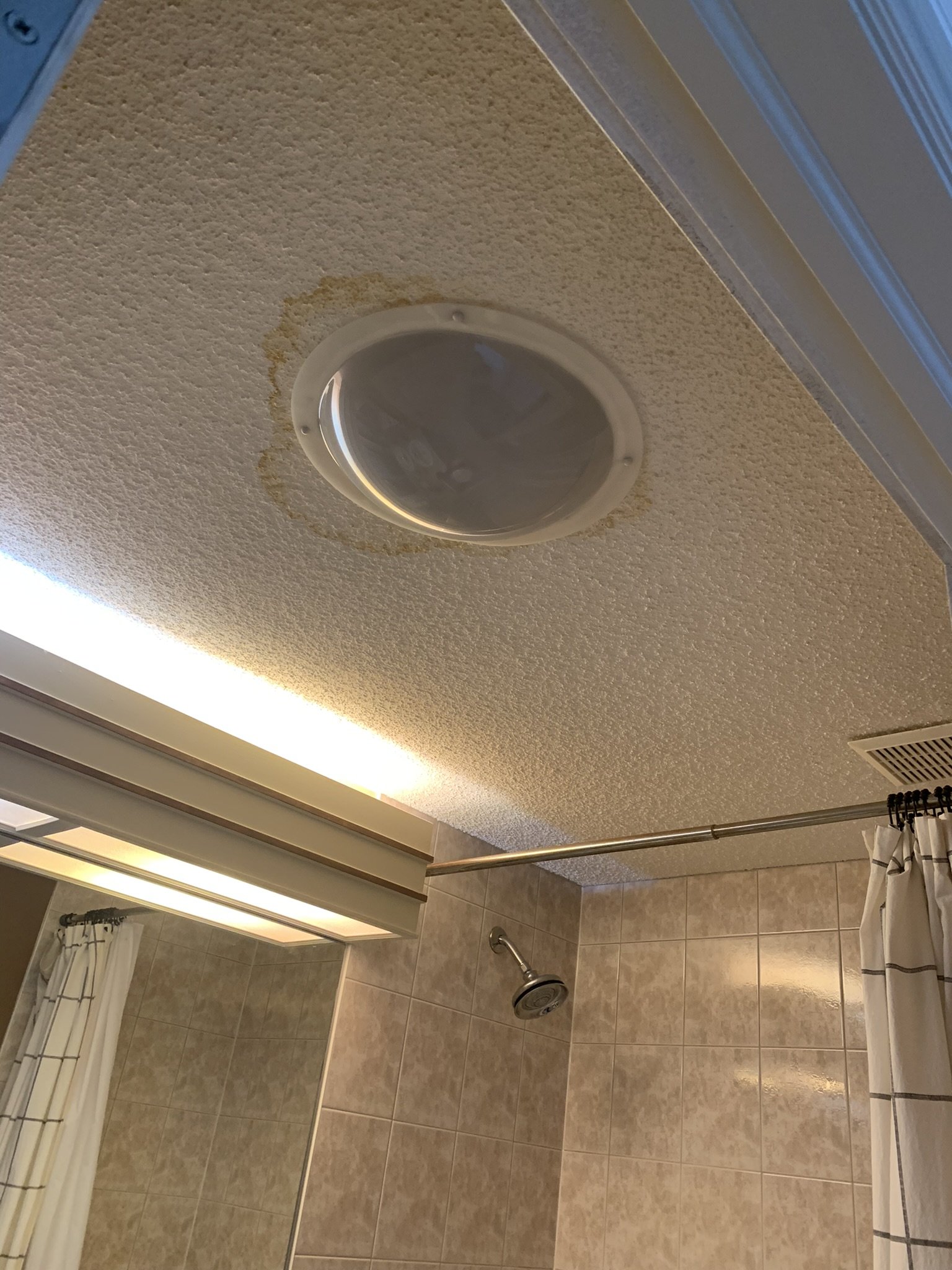 Water damaged popcorn ceiling in the bathroom