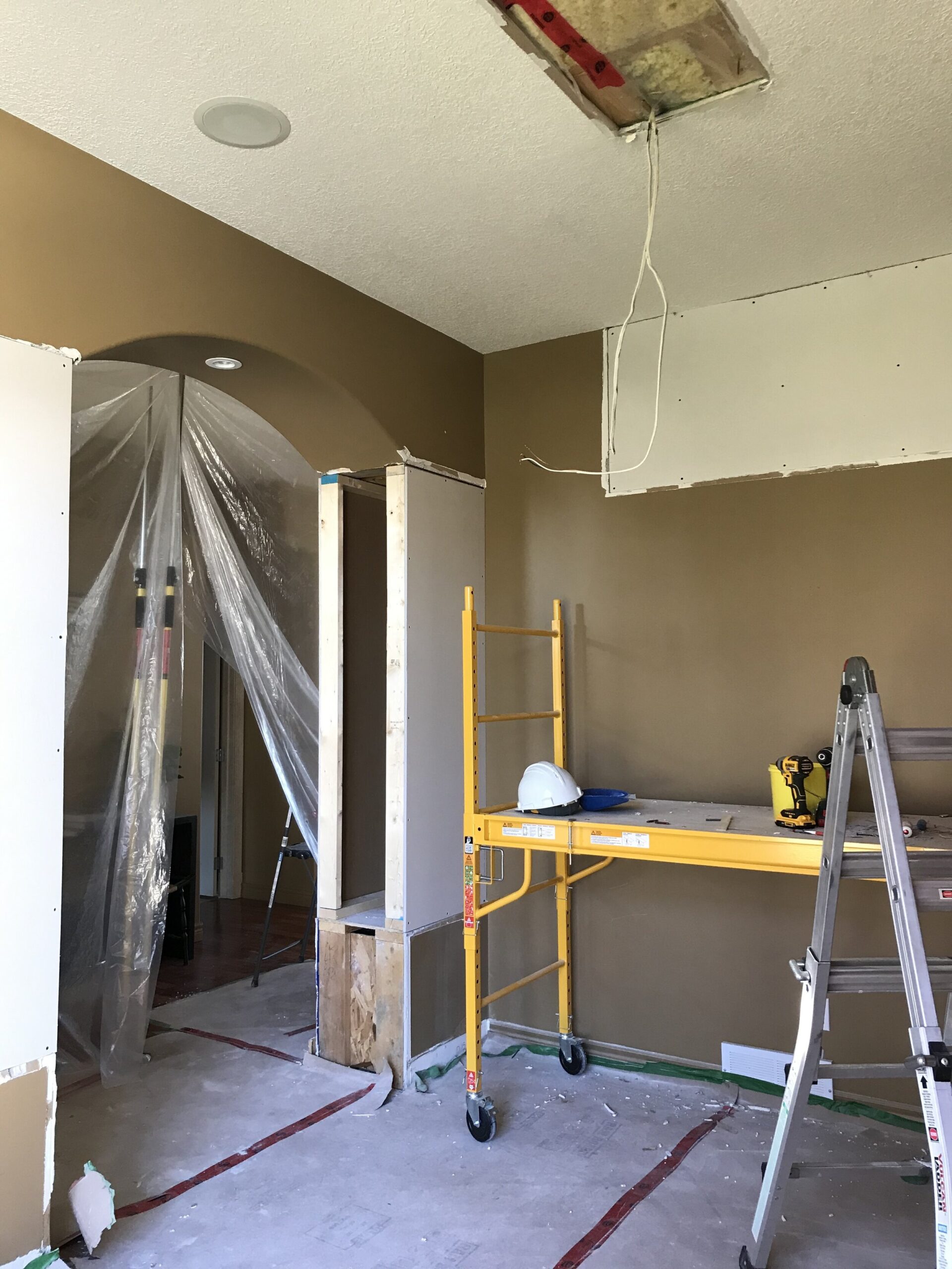 Dining room with columns removed and box removed from ceiling with a scaffold and ladder iin place