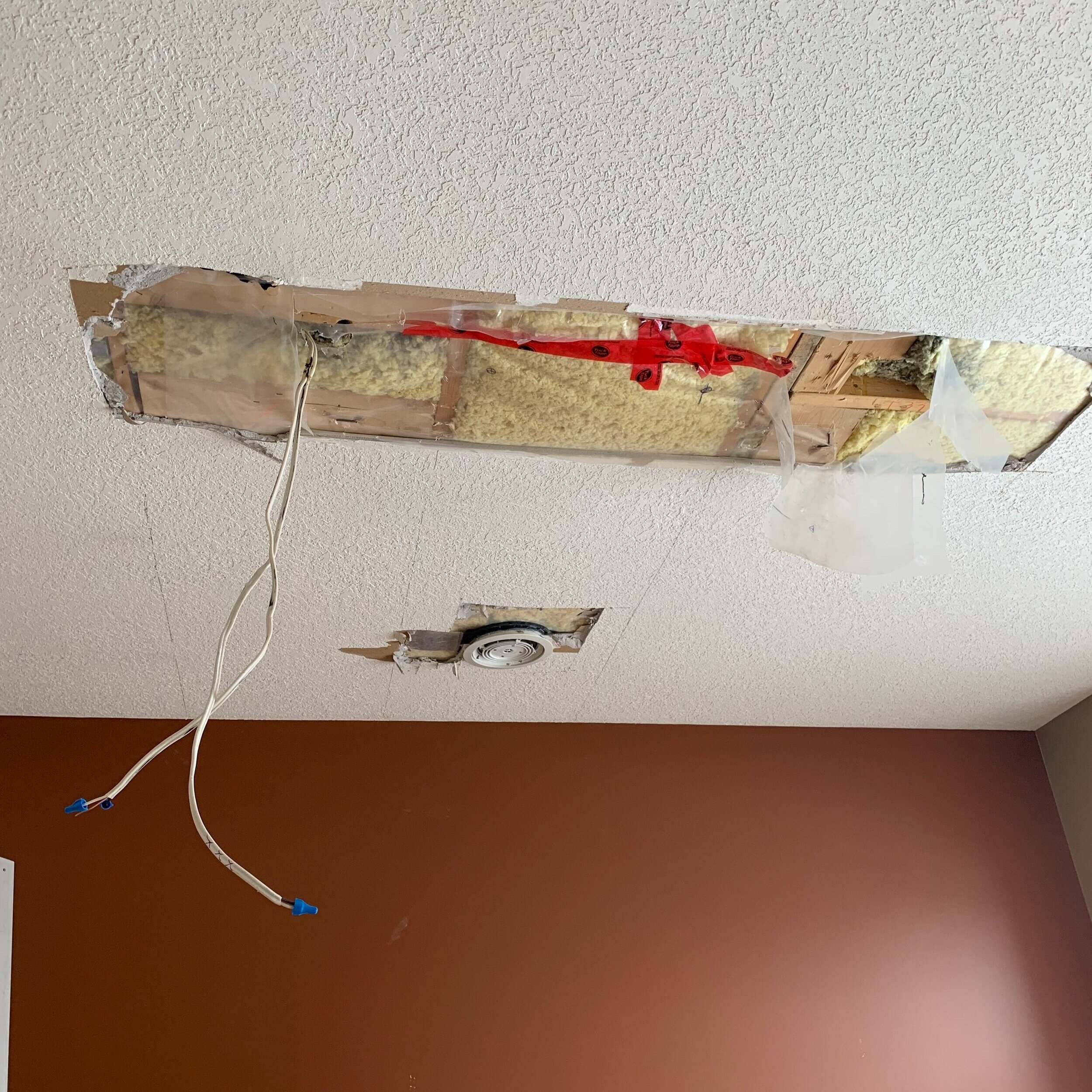 hole in ceiling with wired hanging down and insulation exposed