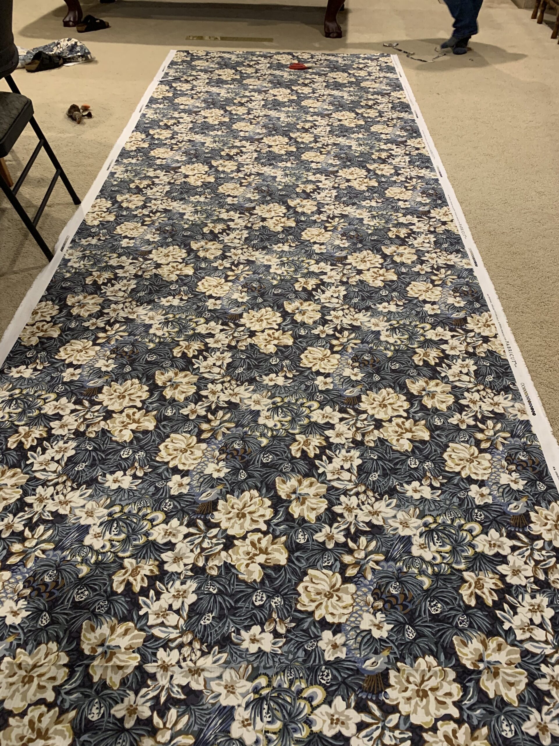 blue floral fabric layed out on the floor
