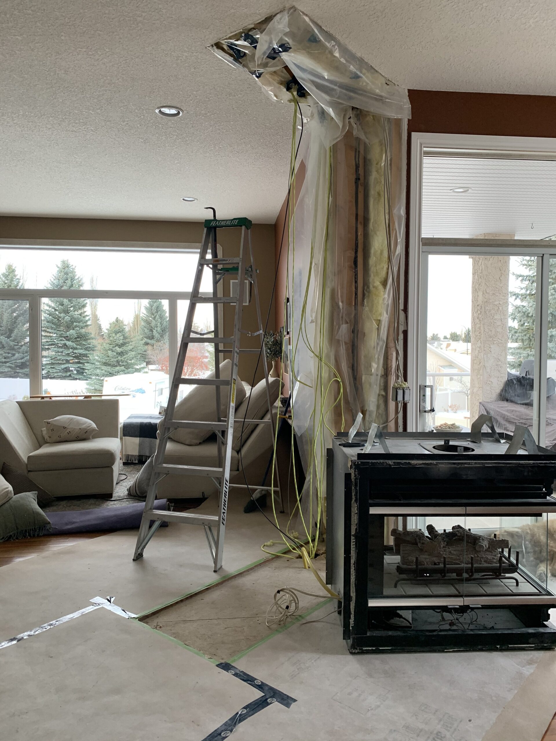 Fireplace removed and wires and drywall hanging
