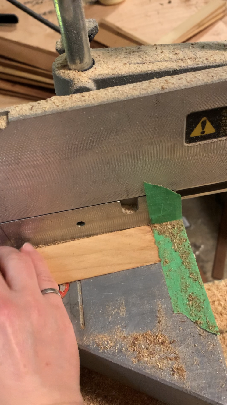 tape placed on a mitre saw to mark the legth to cut cedar shims