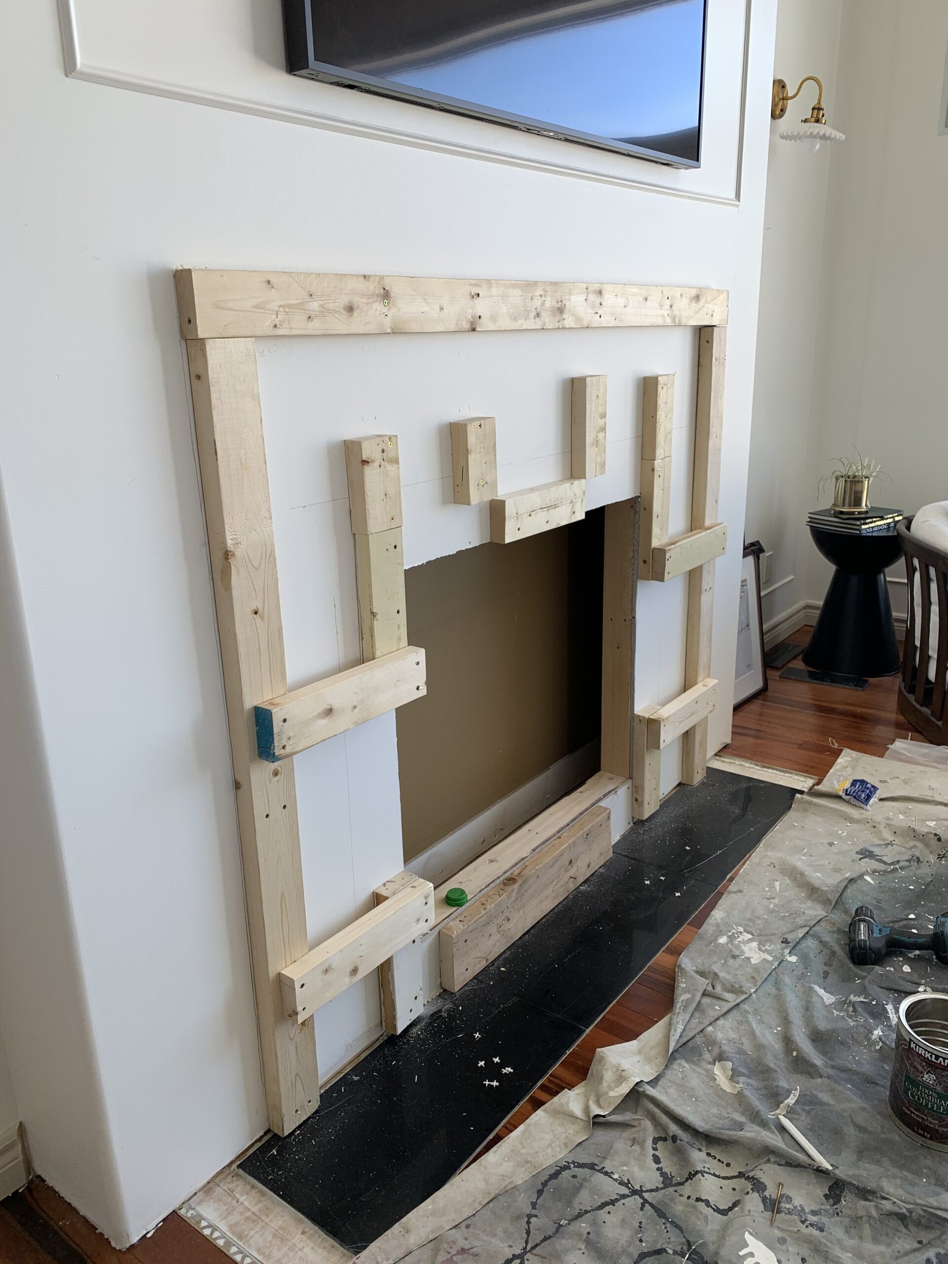 building out wood on the front of the mantel opening 