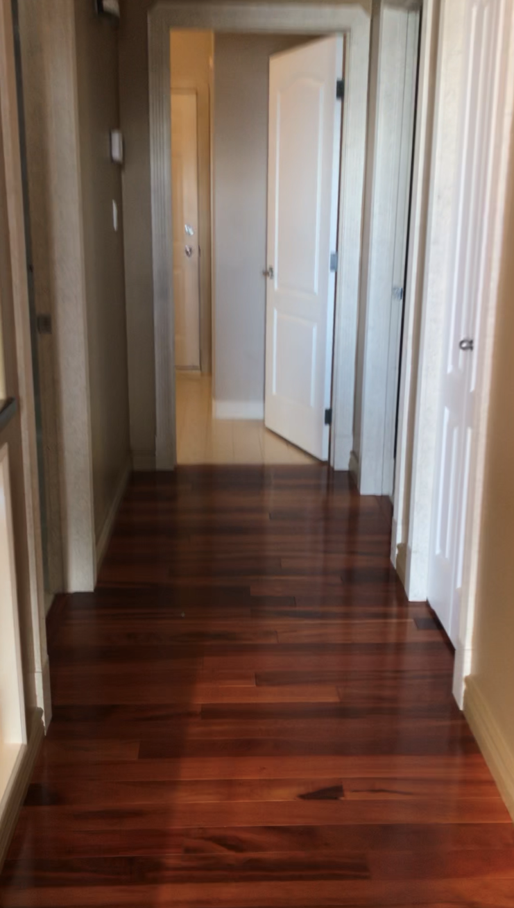 hallway with wood flooring, a lot of doors opening to it and white doors