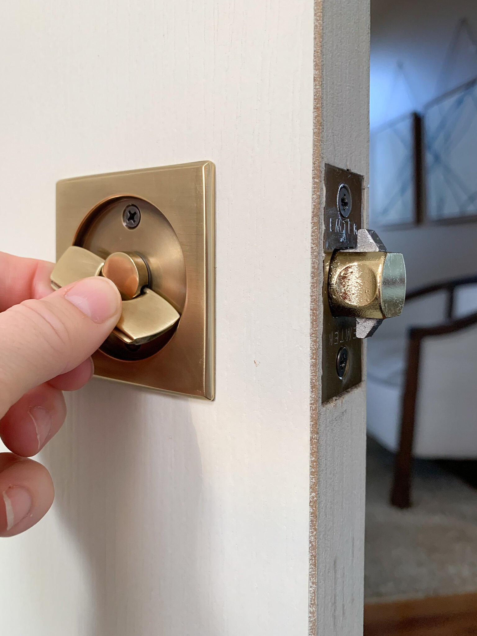 Pocket door latch in antique brass being turned 