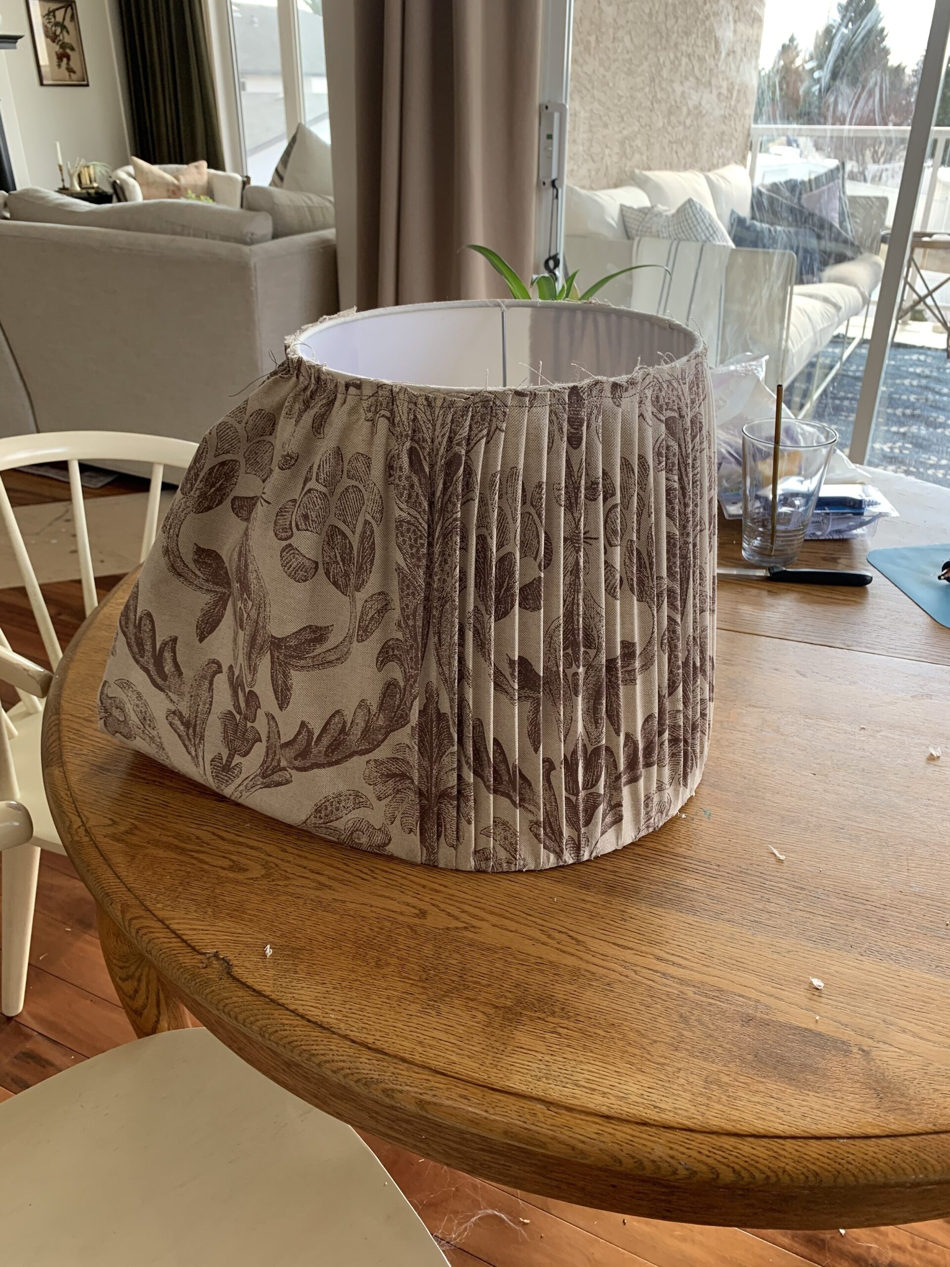 adding fabric to a lampshade with pleating, partially complete