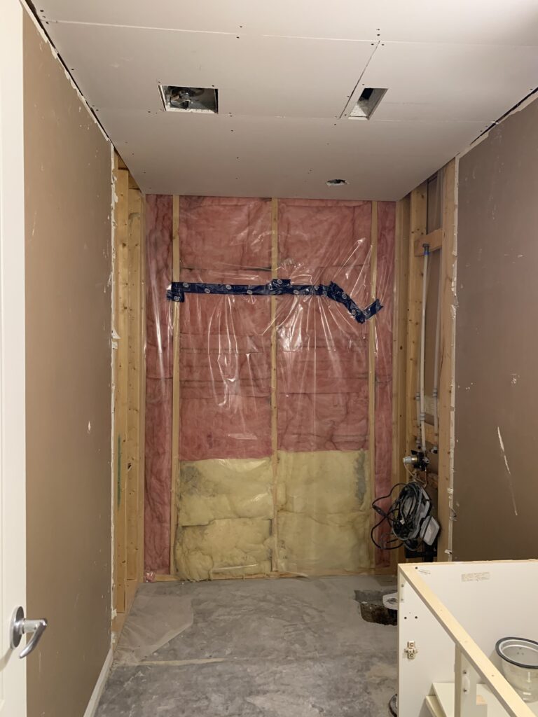 Room with new ceiling drywall, tub and drywall missing, flooring missing, vanity with no doors