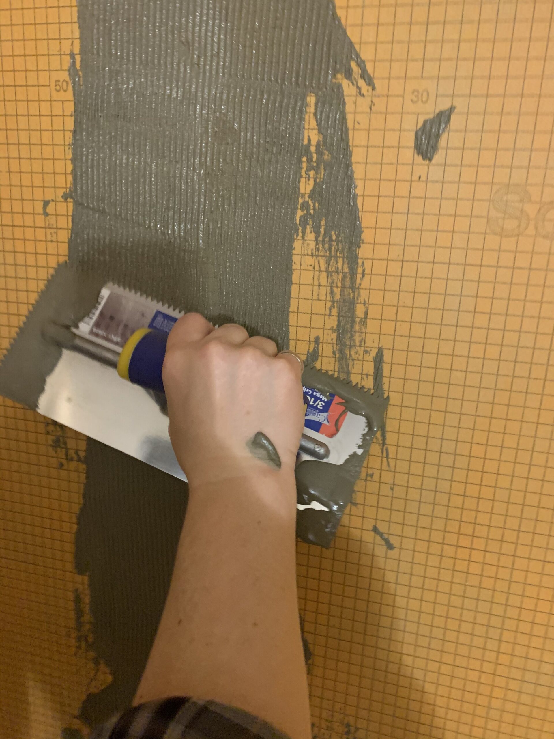 adding grout to seams between kerdi board