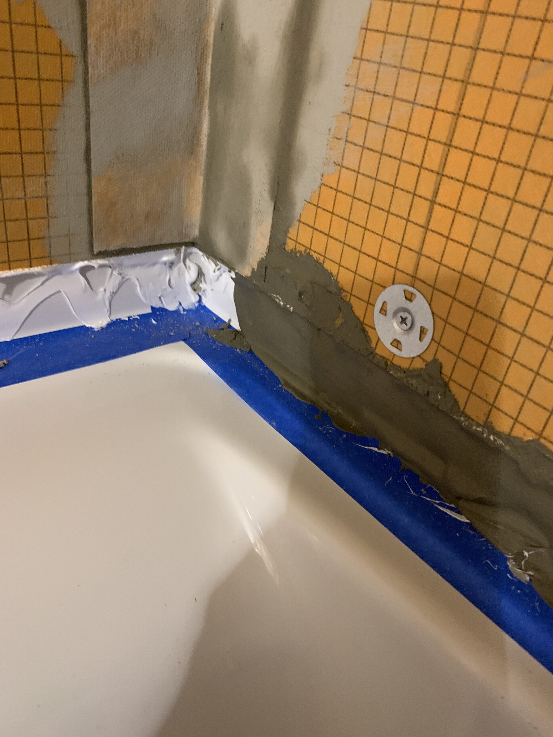 kerdi fix spread on the tub flange and then topped with mortar