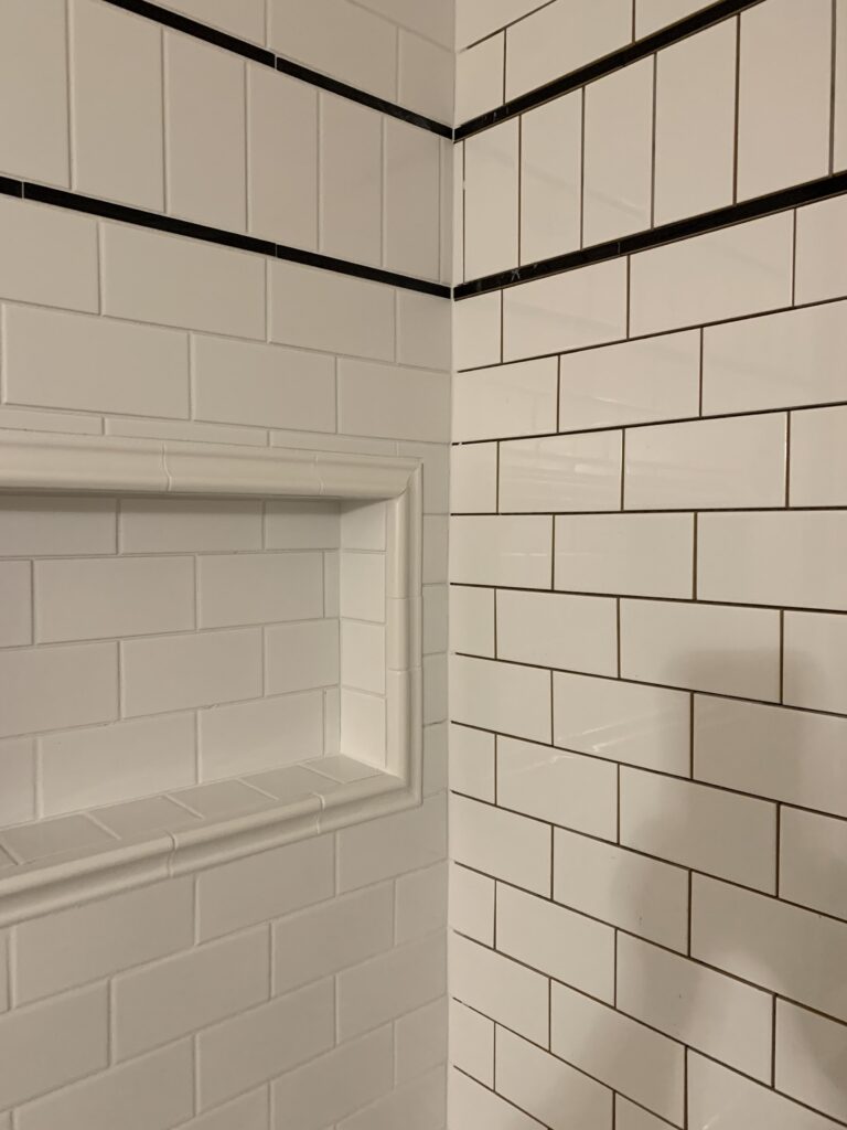 image showing left half of tile surround subway tile grouted and right side not grouted