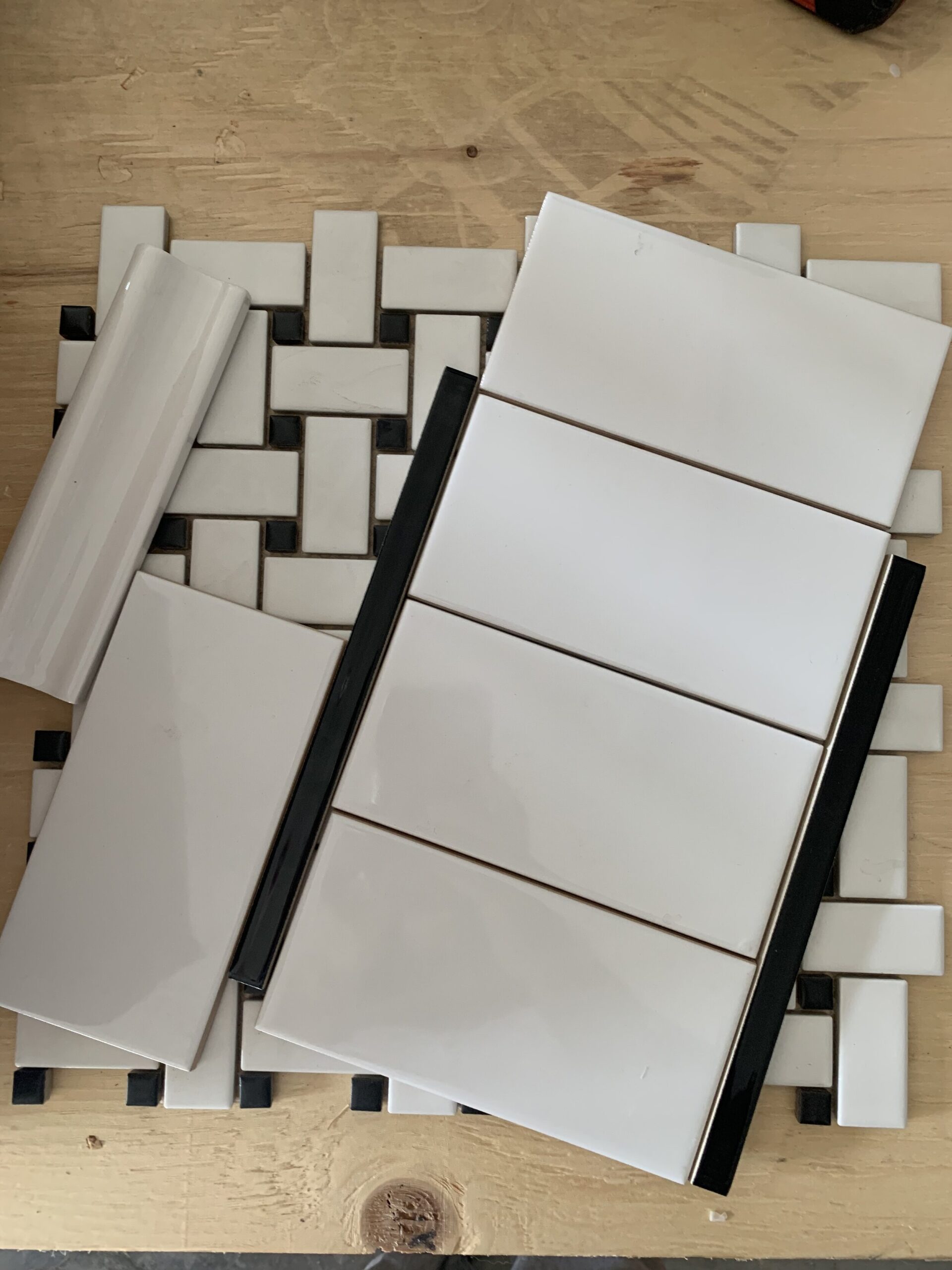 Various black and white ceramic tiles layed out 