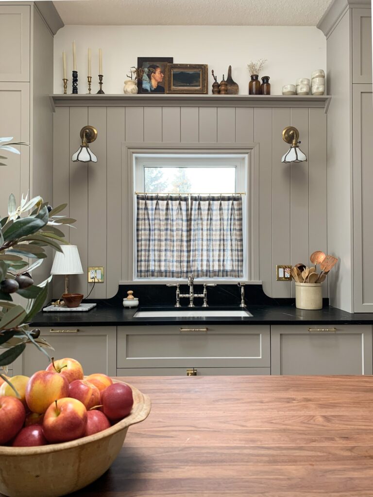 Modern traditional kitchen sink with shelf above and curved soapstone backsplash