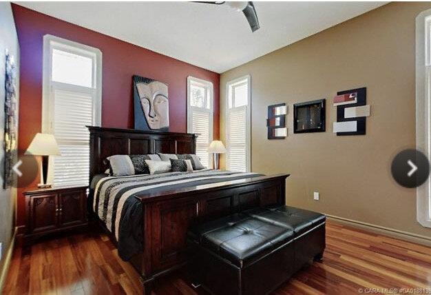 real estate listing showing brown and red walls, large wood furniture