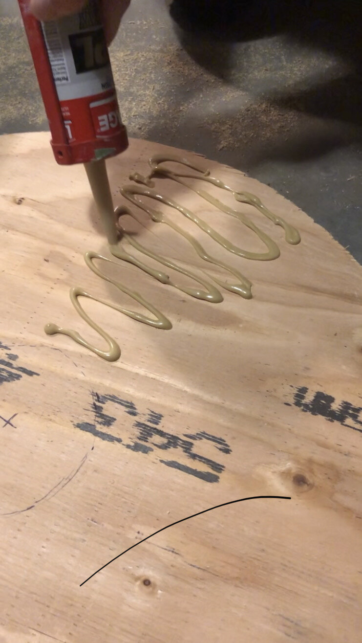 spreading adhesive on a plywood panel