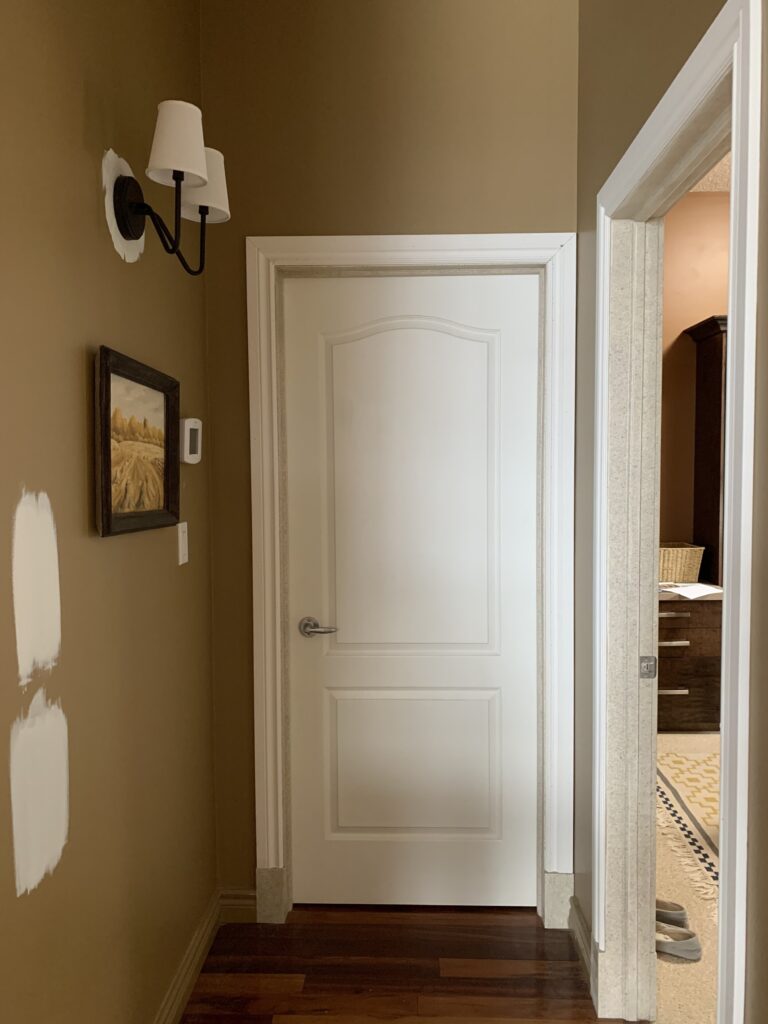 Before hallway prior to painting or adding moulding with brown walls