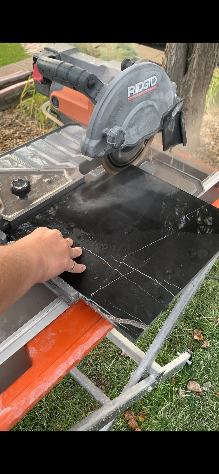 Cutting black marble tile into 1" strips on wet tile saw