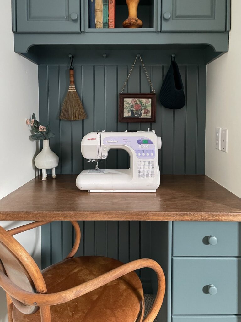 built in desk with knoxville gray painted cabnetry, maple stained desk top, vintage bentwood chair, a pegrail and beadboard backsplash