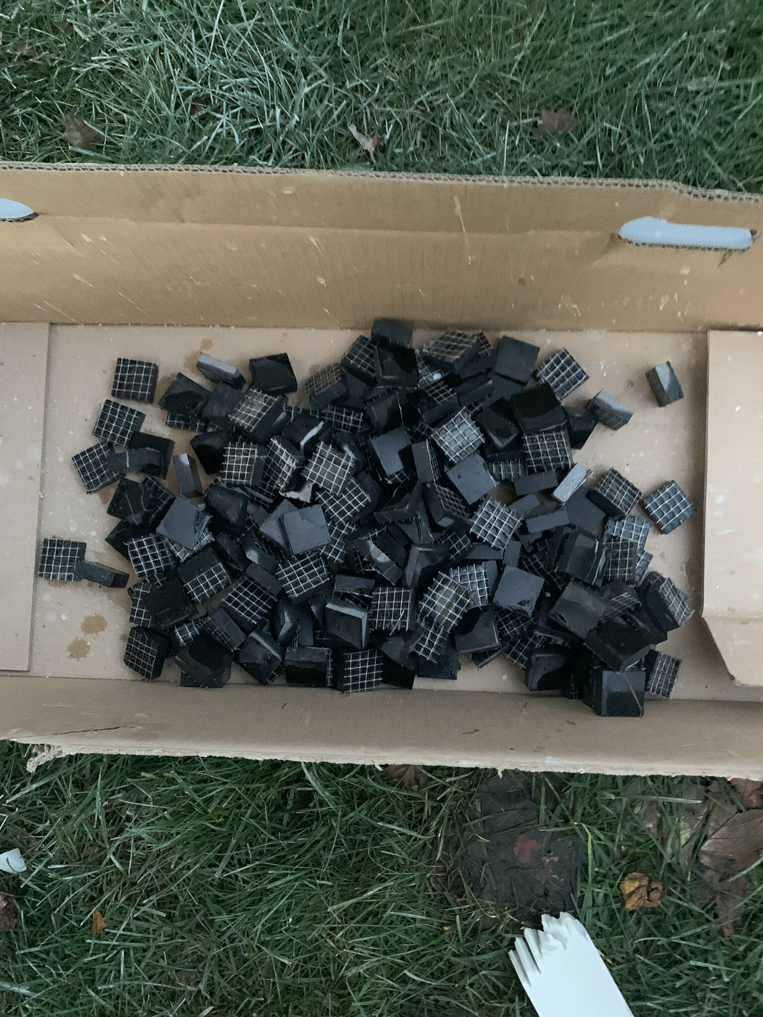 Pile of finished black marble squares cut 1 inch square
