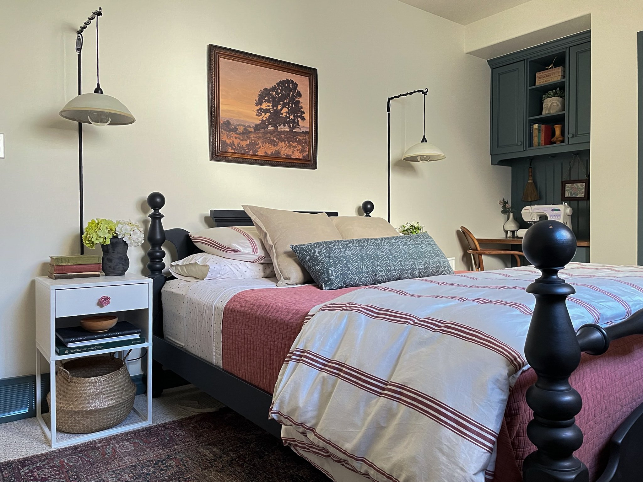 guest room with black bed, pink and green colour palette