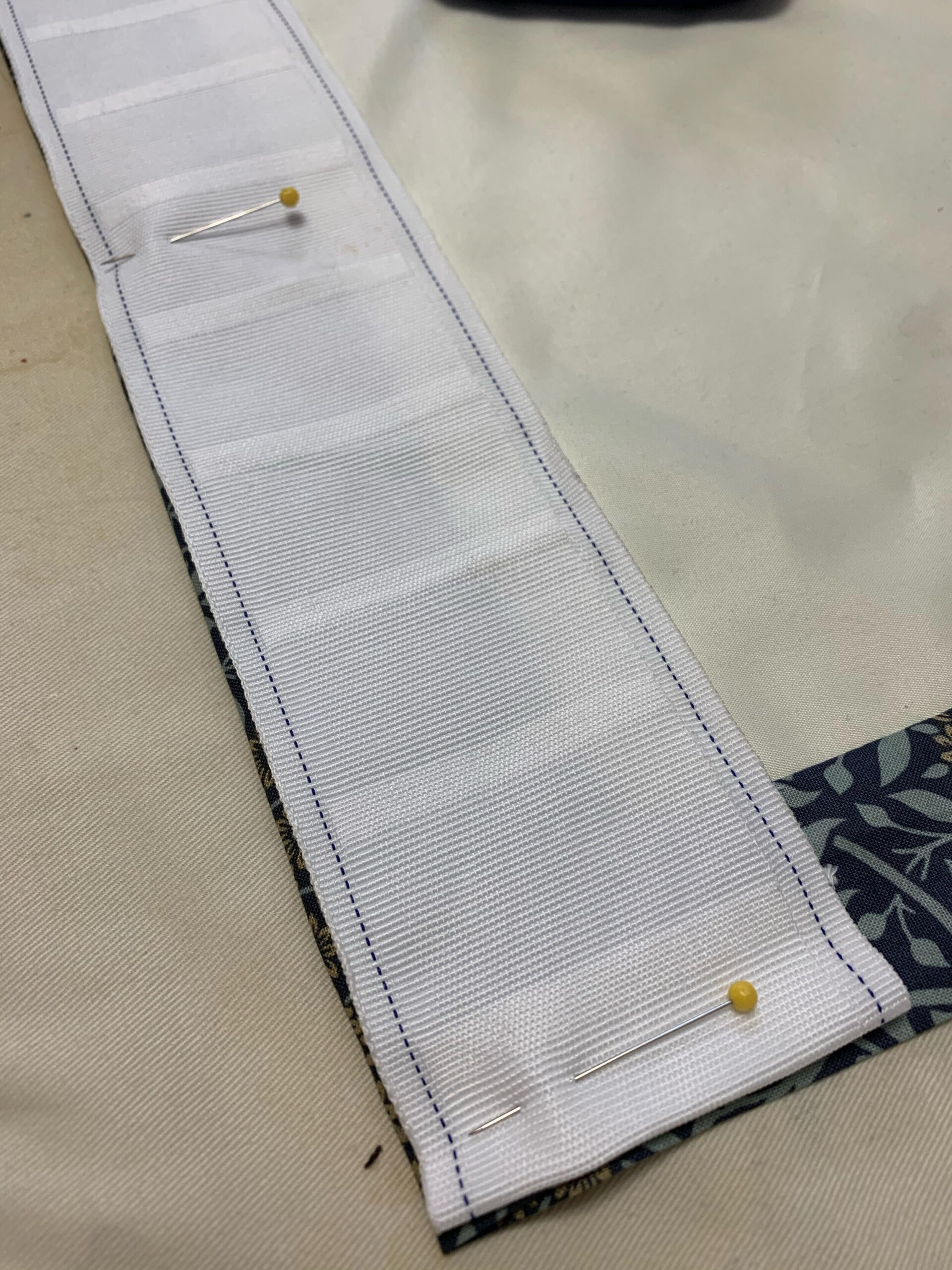 pleat tape pinned to the top of the curtain