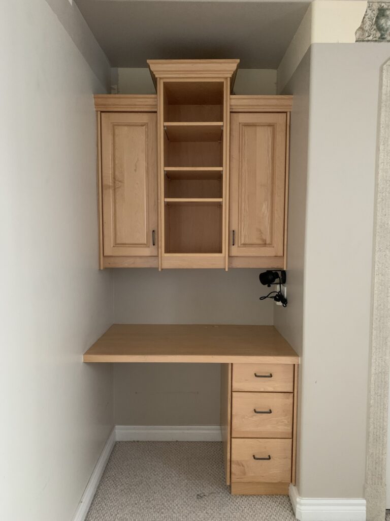 built in desk with maple cabinets, staggered top cabinets not going to the ceiling