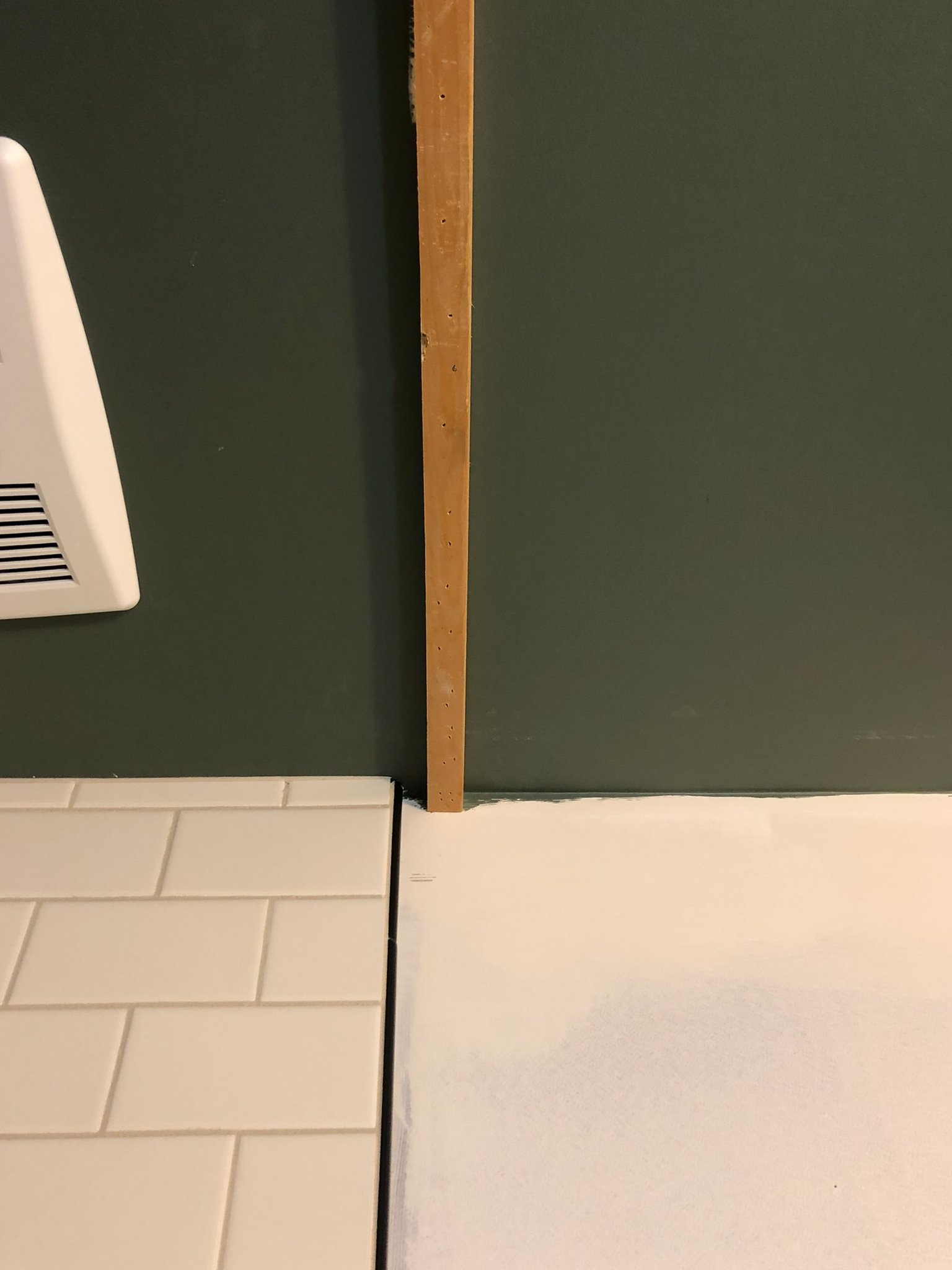 small piece of wood as a nailer added on a ceiling accross the shower