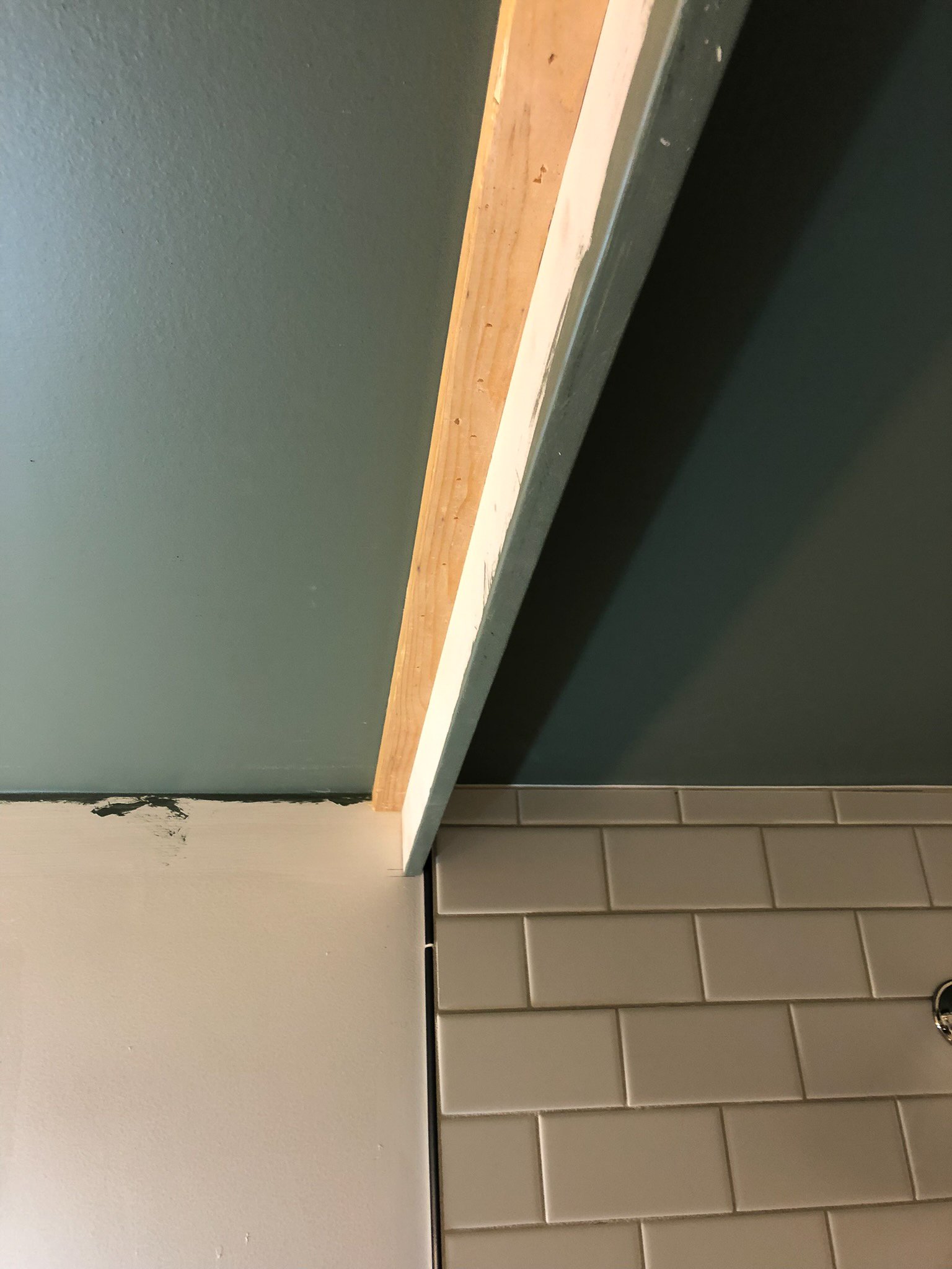 1x4" valence added in front of  shower, nailed to nailer in ceiling