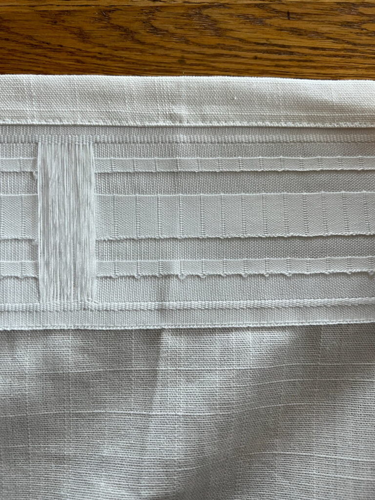 Pleater tape on the inside top and back of Ikea curtains