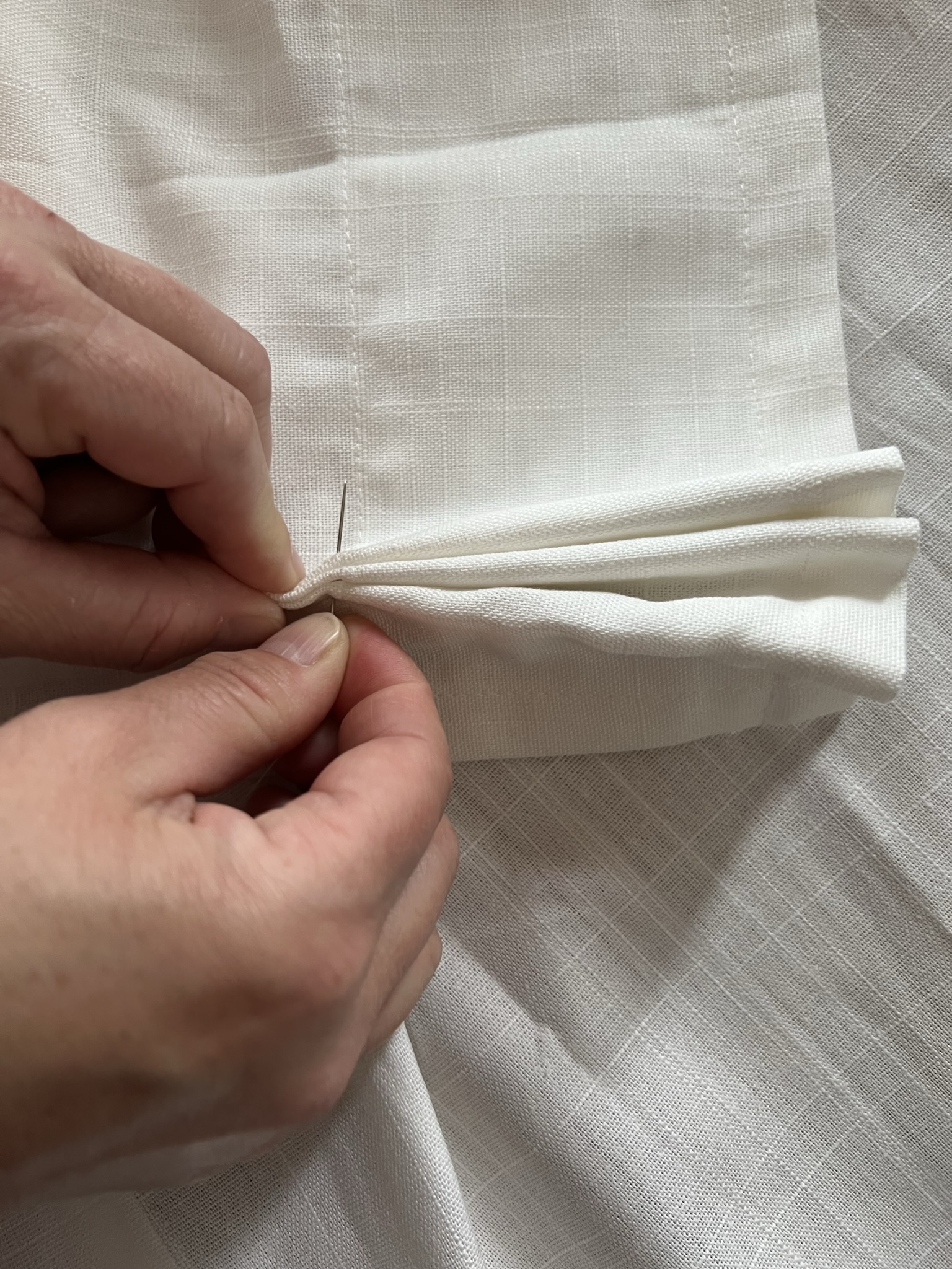 Hand stitching the base of the pleats 