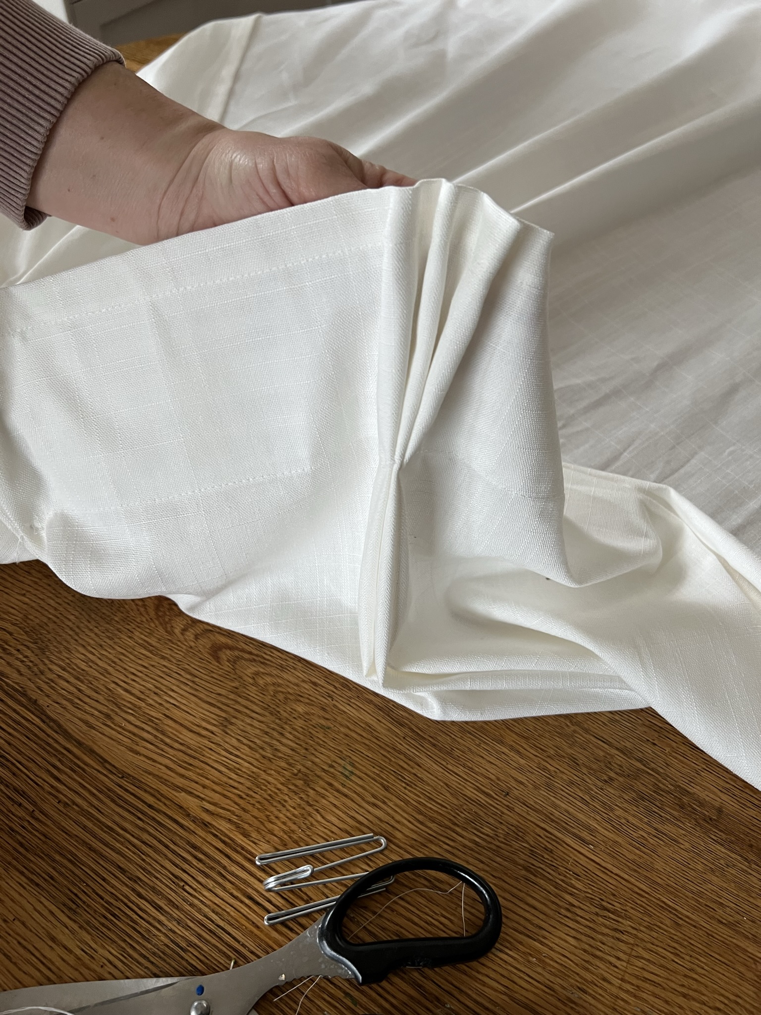 holding up a triple pinch pleat at the top of a curtain with a stitch added 