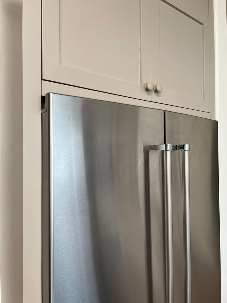 Close up showing fillers installed flush with the fridge