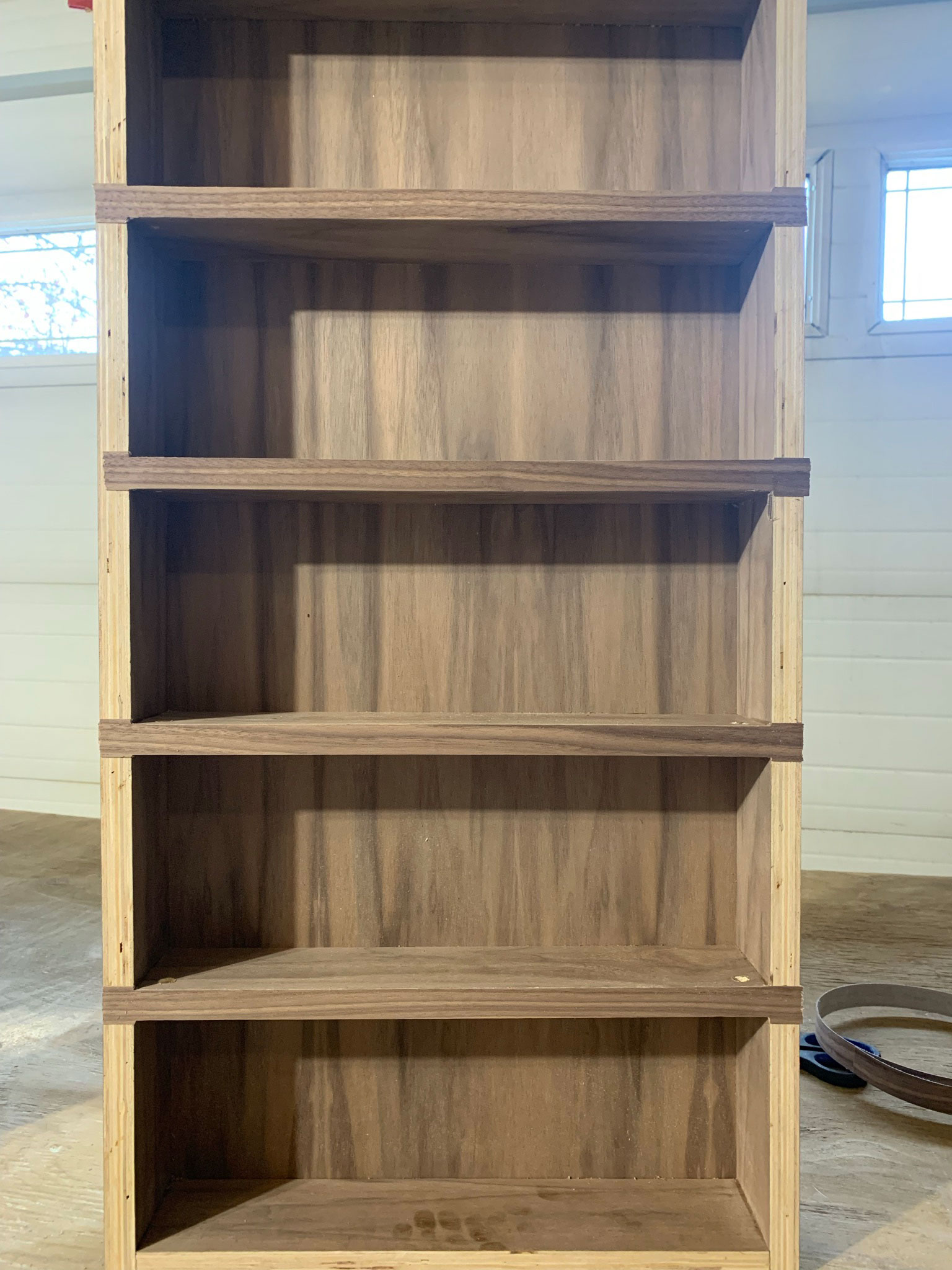 DIY wood and brass spice rack with veneer added to the front face of the walnut shelves