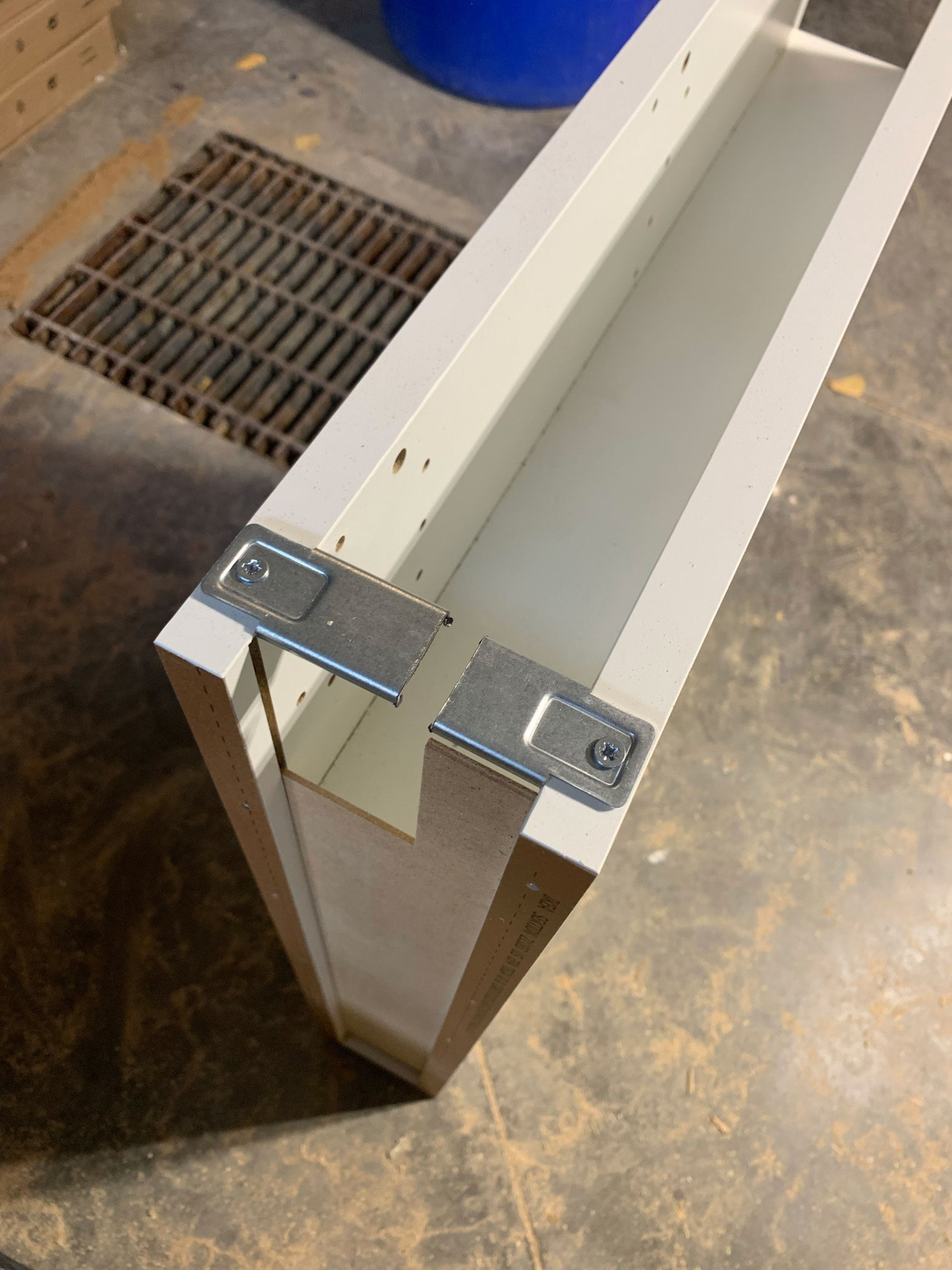 top of cabinet showing a metal brace which has been cut