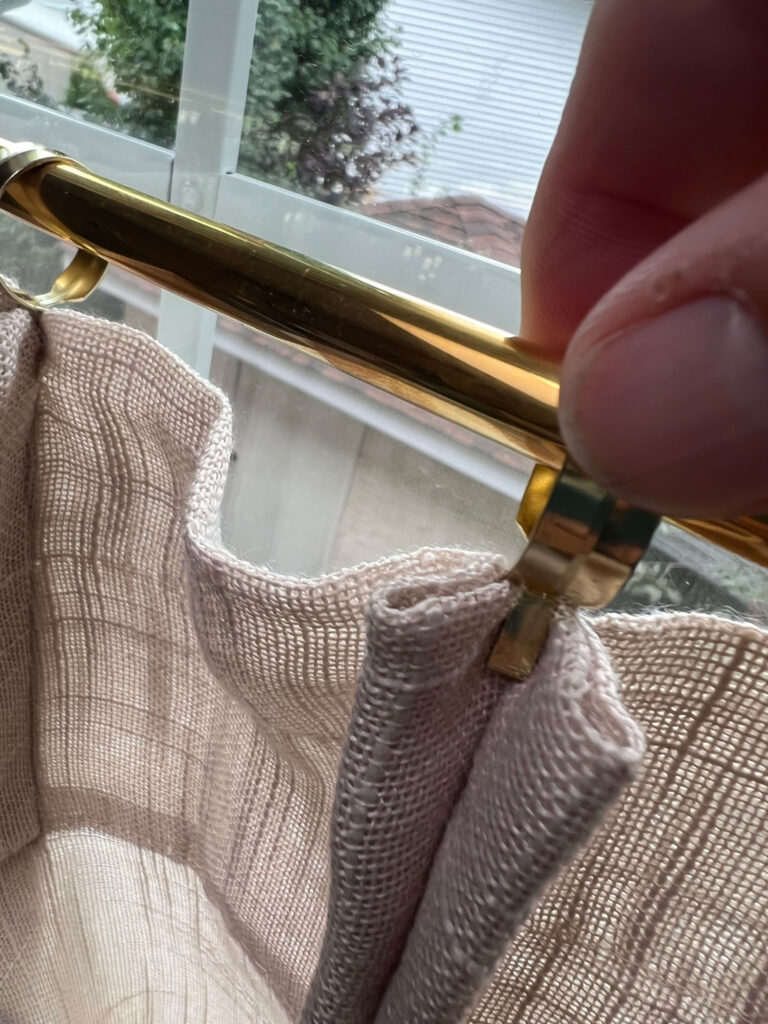 using a pinch style curtain ring to pinch to back of DIY pinch pleat cafe curtains