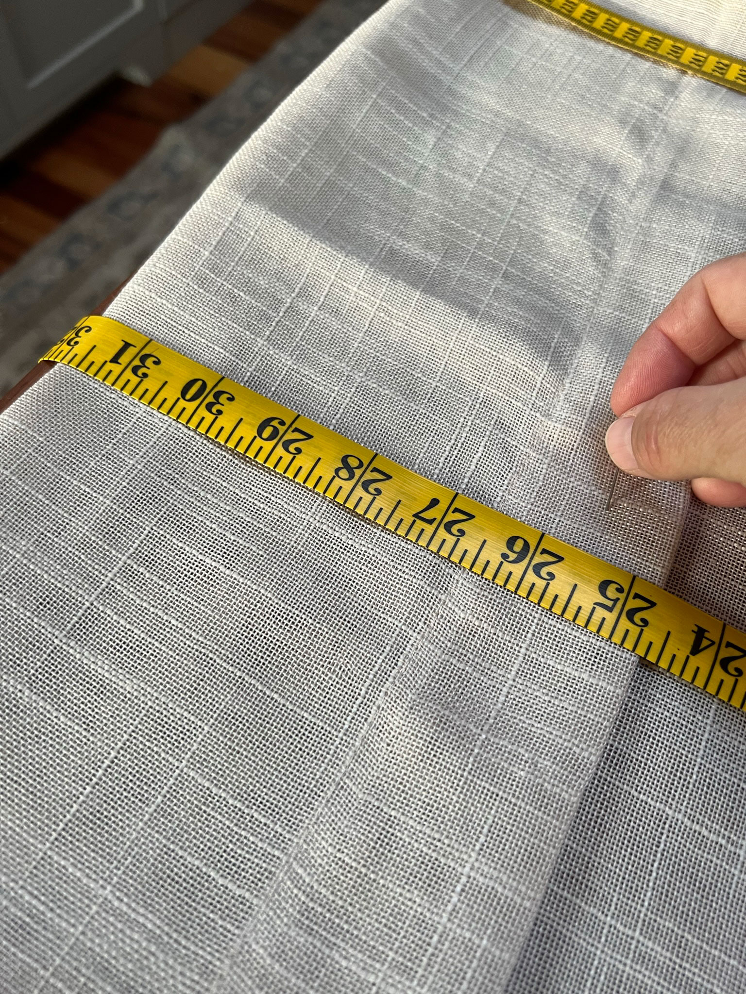 measuring the length of curtains and folding in place