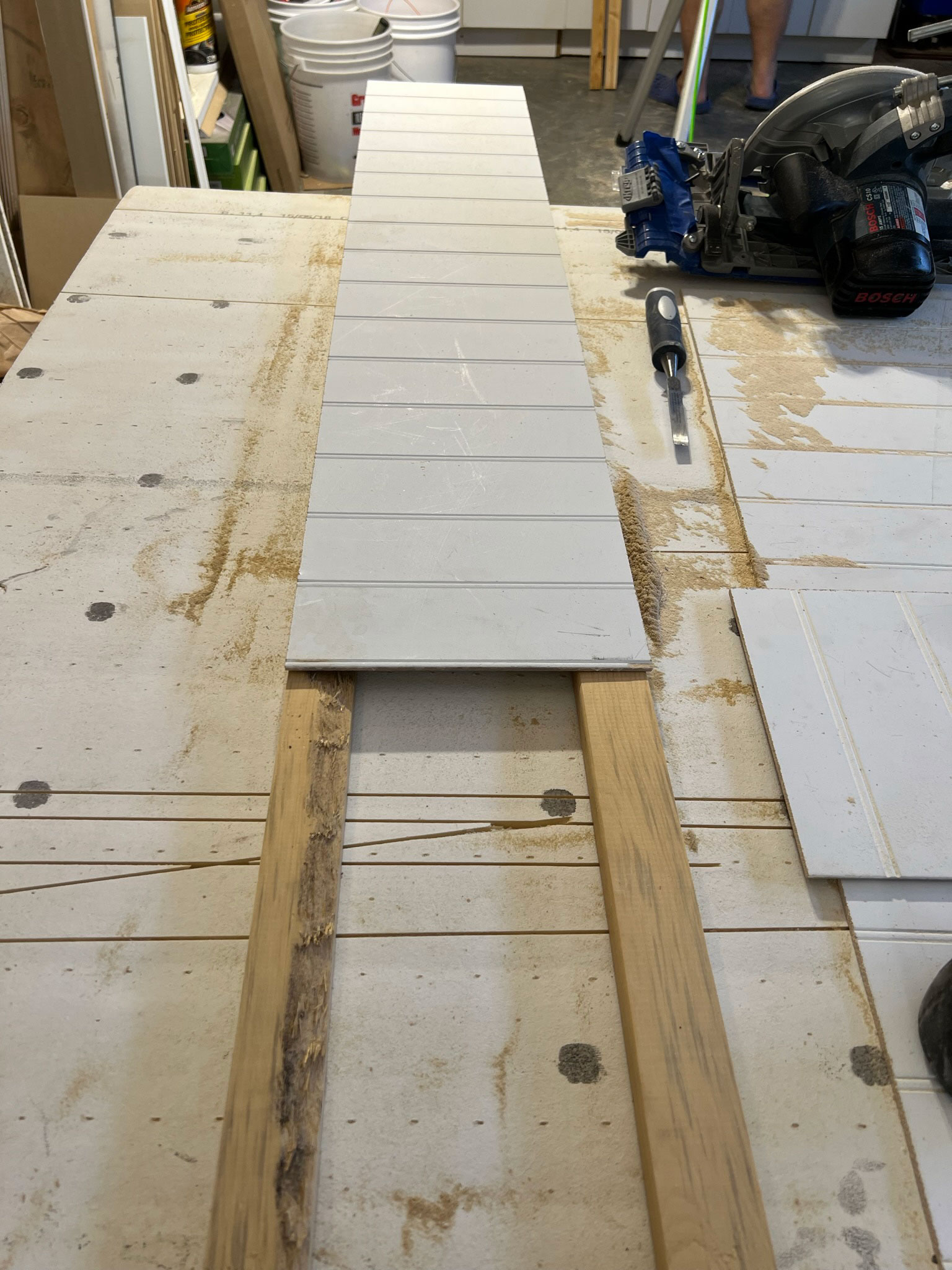beadbaord being nailed to two wood strips