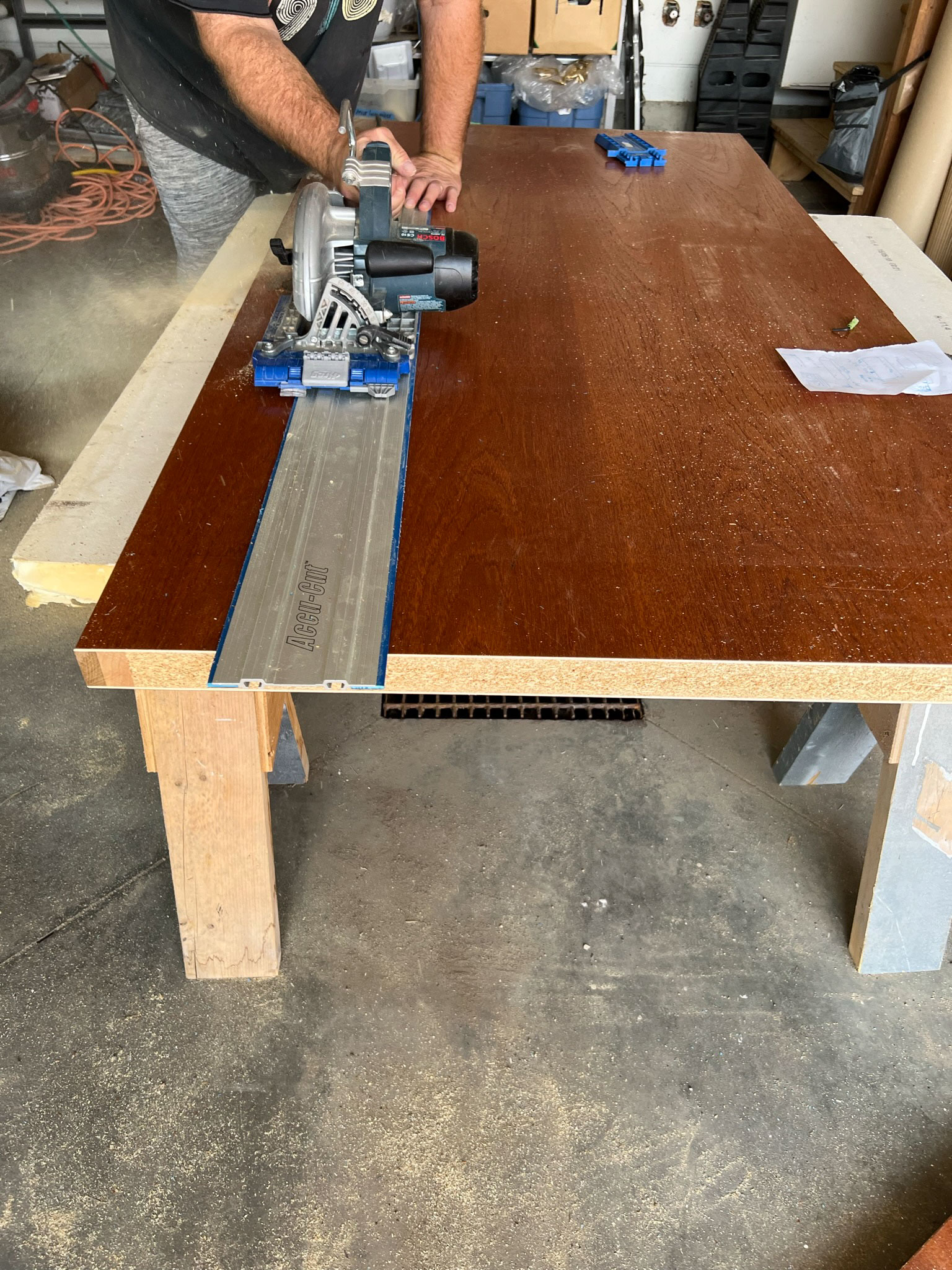 Cutting the wood door using a circular saw with a straight edge guide