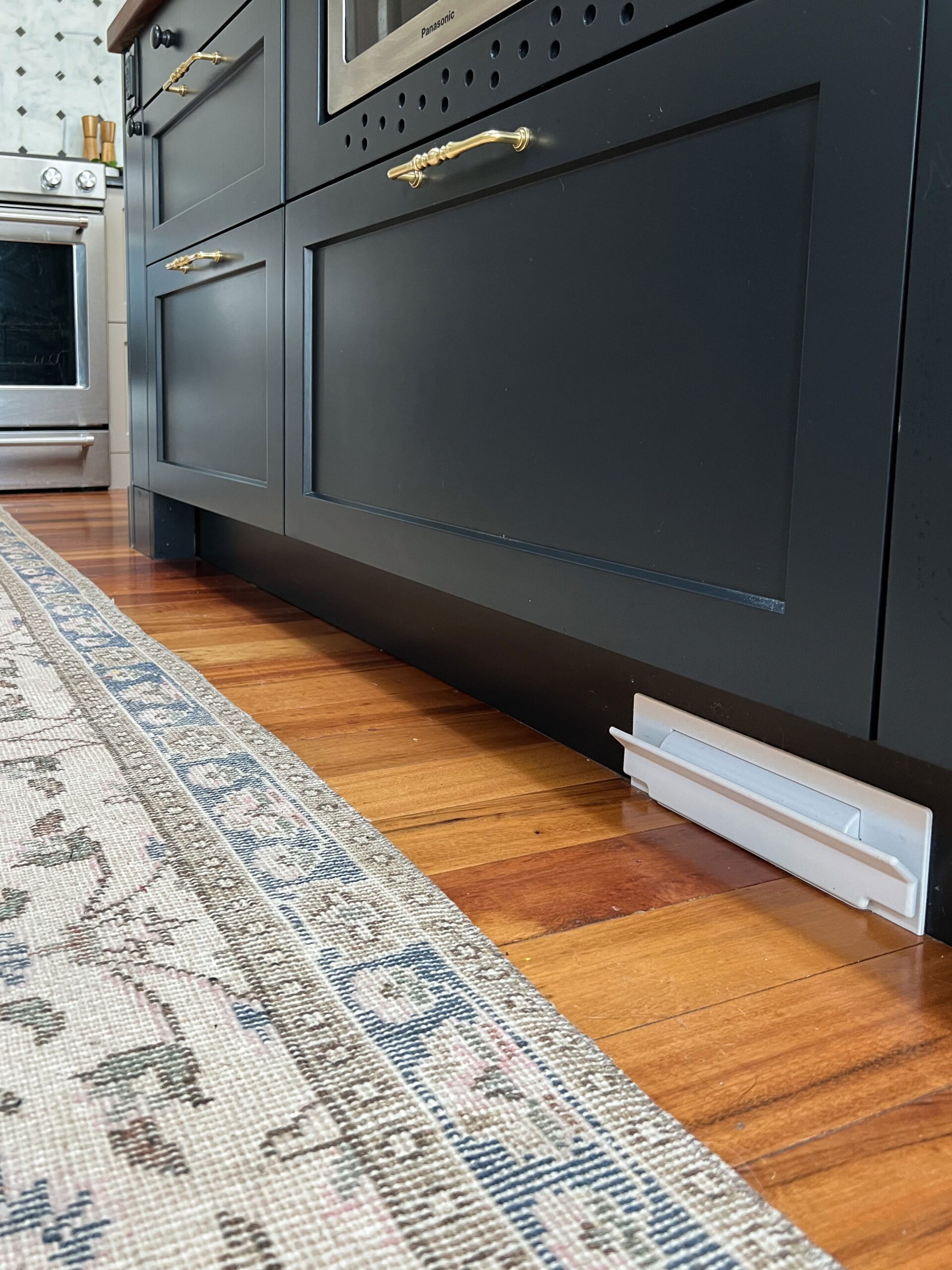 toe kick on black kitchen island, recessed and  with a toe kick vacuum