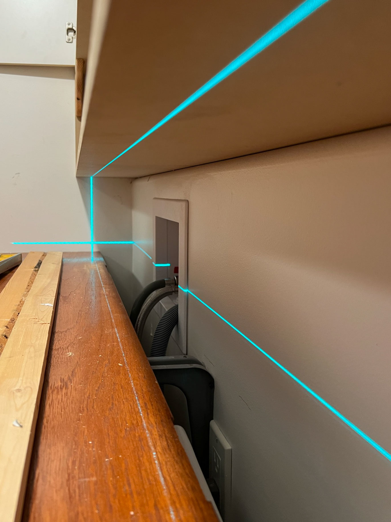 laser level projecting onto a counter and the underside of a shelf