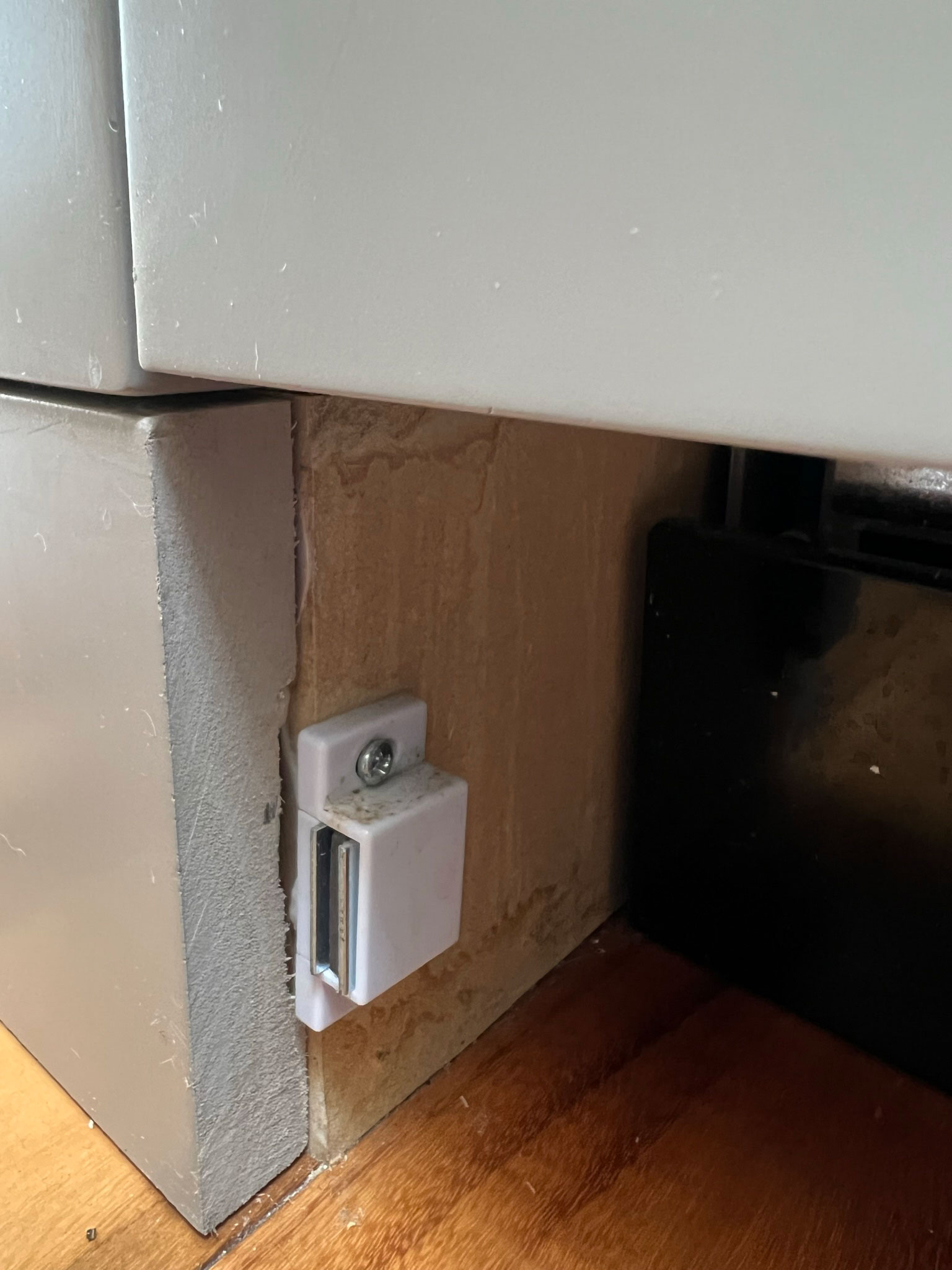magnetic clasp inside the toe kick area under a dishwasher