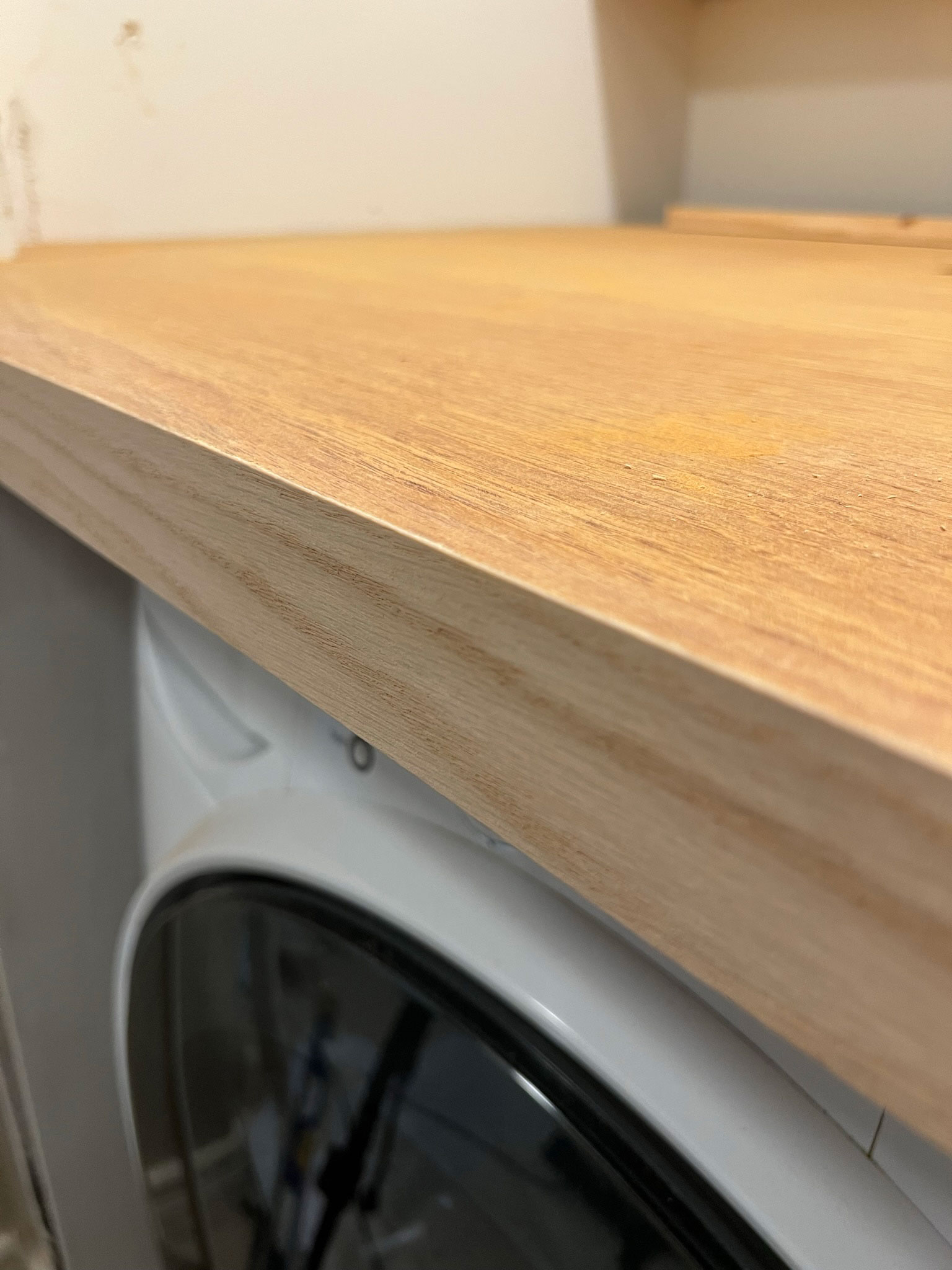 Veneer added to the front of the wood door that we used to make the DIY laundry room countertop, looks like a solid piece of wood